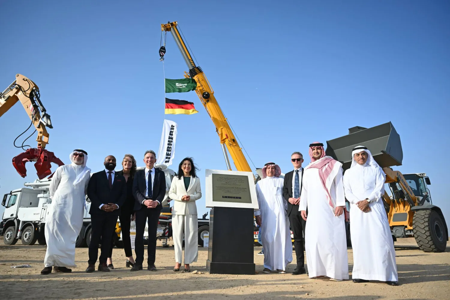 02 February 2026, Saudi Arabia, Jeddah: German Minister for Economic Affairs and Energy Katherina Reiche (C) poses for a photo during a visit to the Mercedes Benz Heavy Duty Trucks and Saudi Liebherr Company Ltd construction site in the Juffali Industrial Park. (dpa)