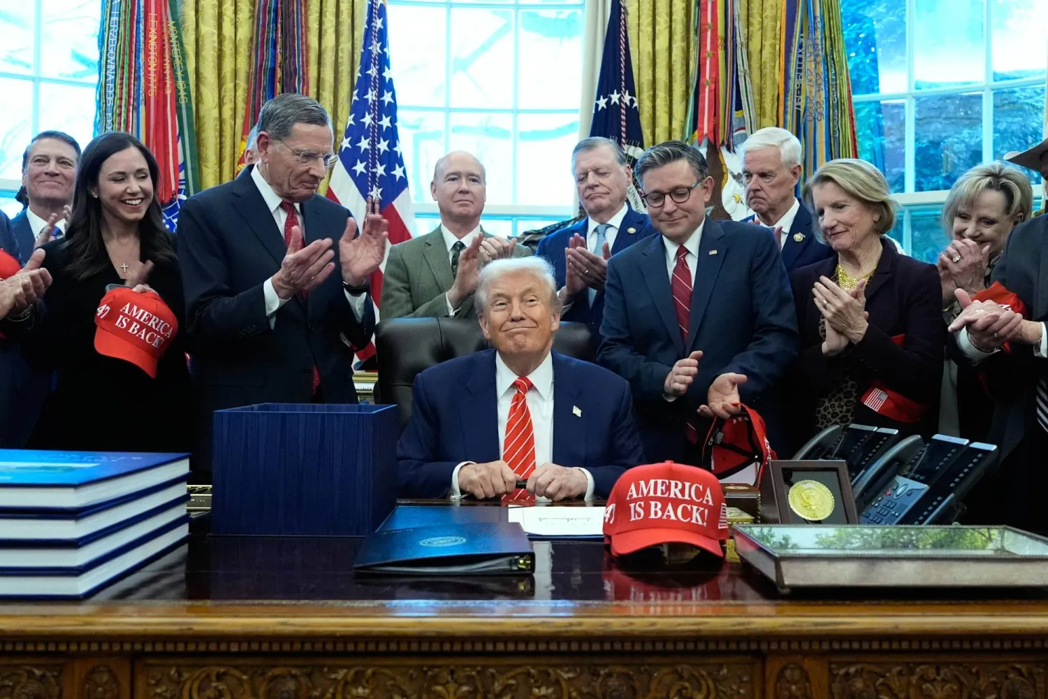 President Donald Trump smiles after signing a spending bill that ends a partial shutdown of the federal government in the Oval Office of the White House, Tuesday, Feb. 3, 2026, in Washington. (AP)