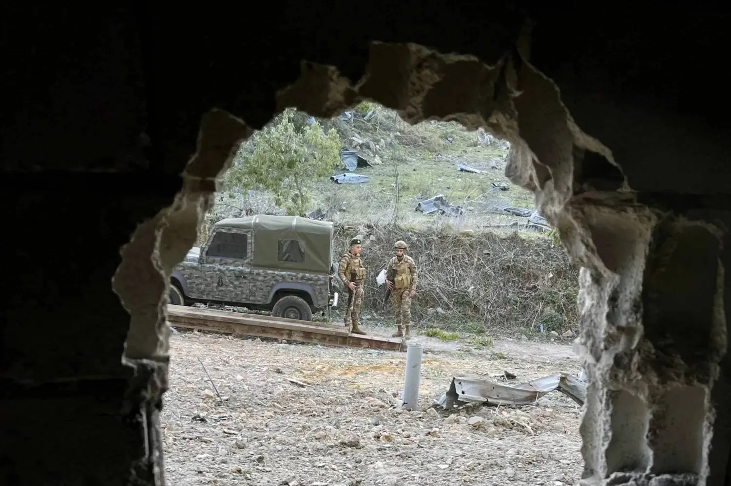 Lebanese army soldiers inspect the site of an Israeli strike in Kfardounine, southern Lebanon (EPA)