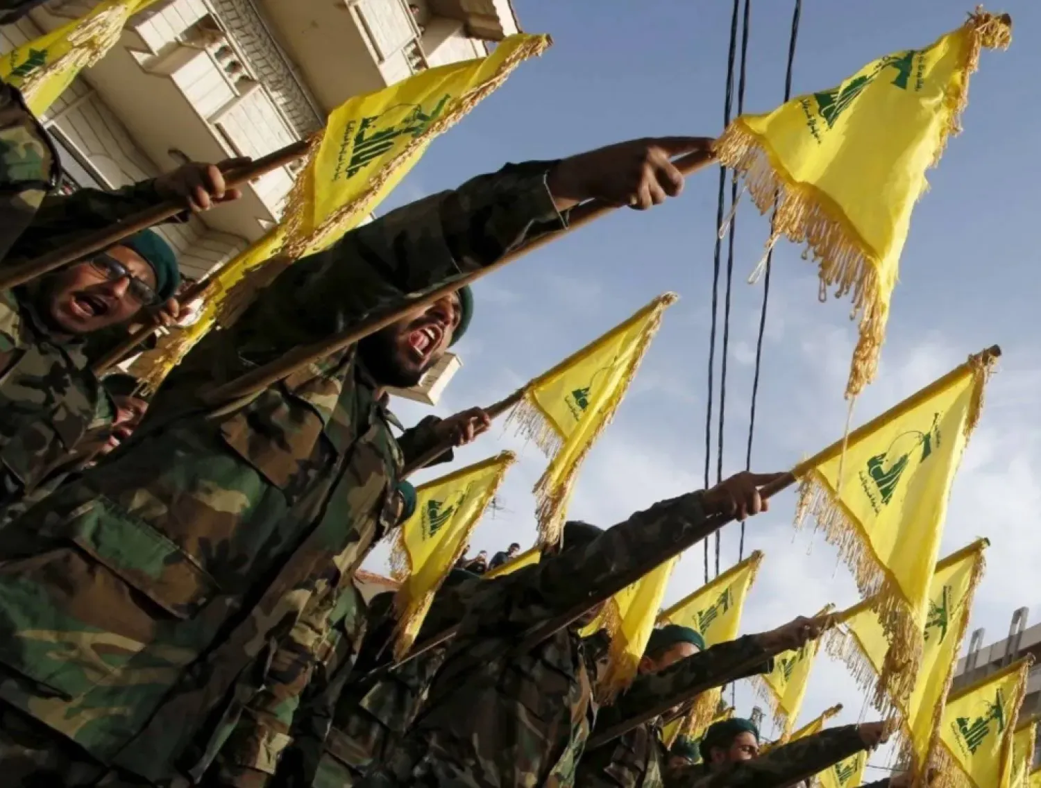Lebanon’s Hezbollah members carry Hezbollah flags during the funeral of a fellow fighter, in al-Ghaziyeh village, southern Lebanon May 26, 2015. REUTERS/Ali Hashisho
