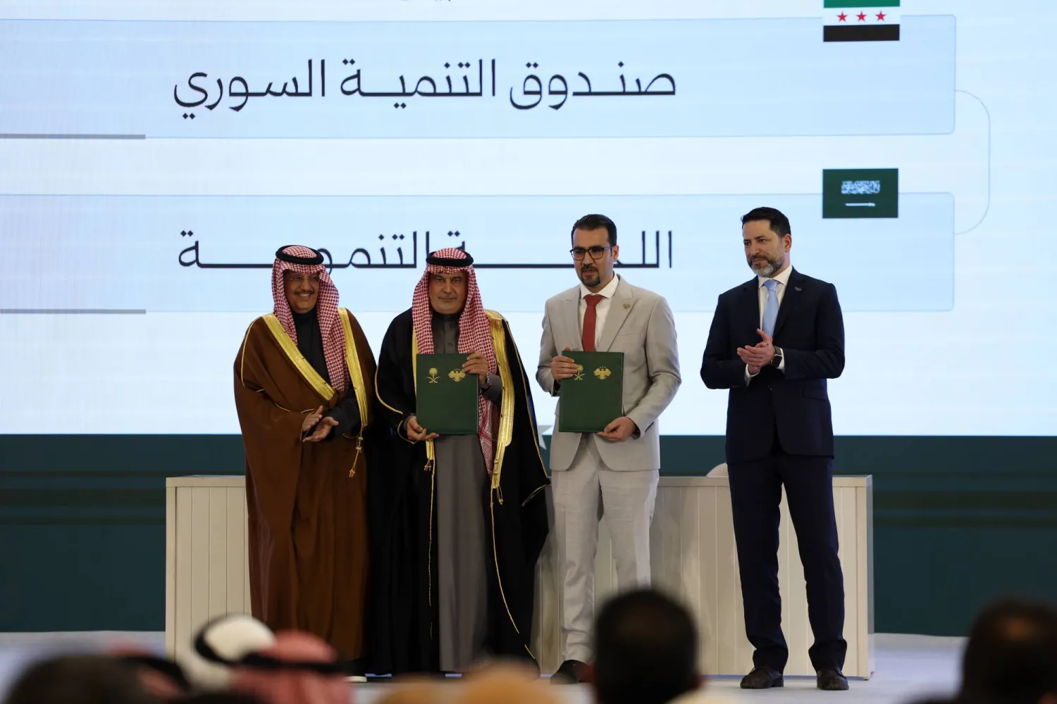 Officials pose after signing a framework agreement for developmental cooperation and the launch of 45 development initiatives between the Syrian Development Fund and Saudi Arabia's Development Committee at the People's Palace in Damascus, Syria, Saturday, Feb. 7, 2026. (AP) 