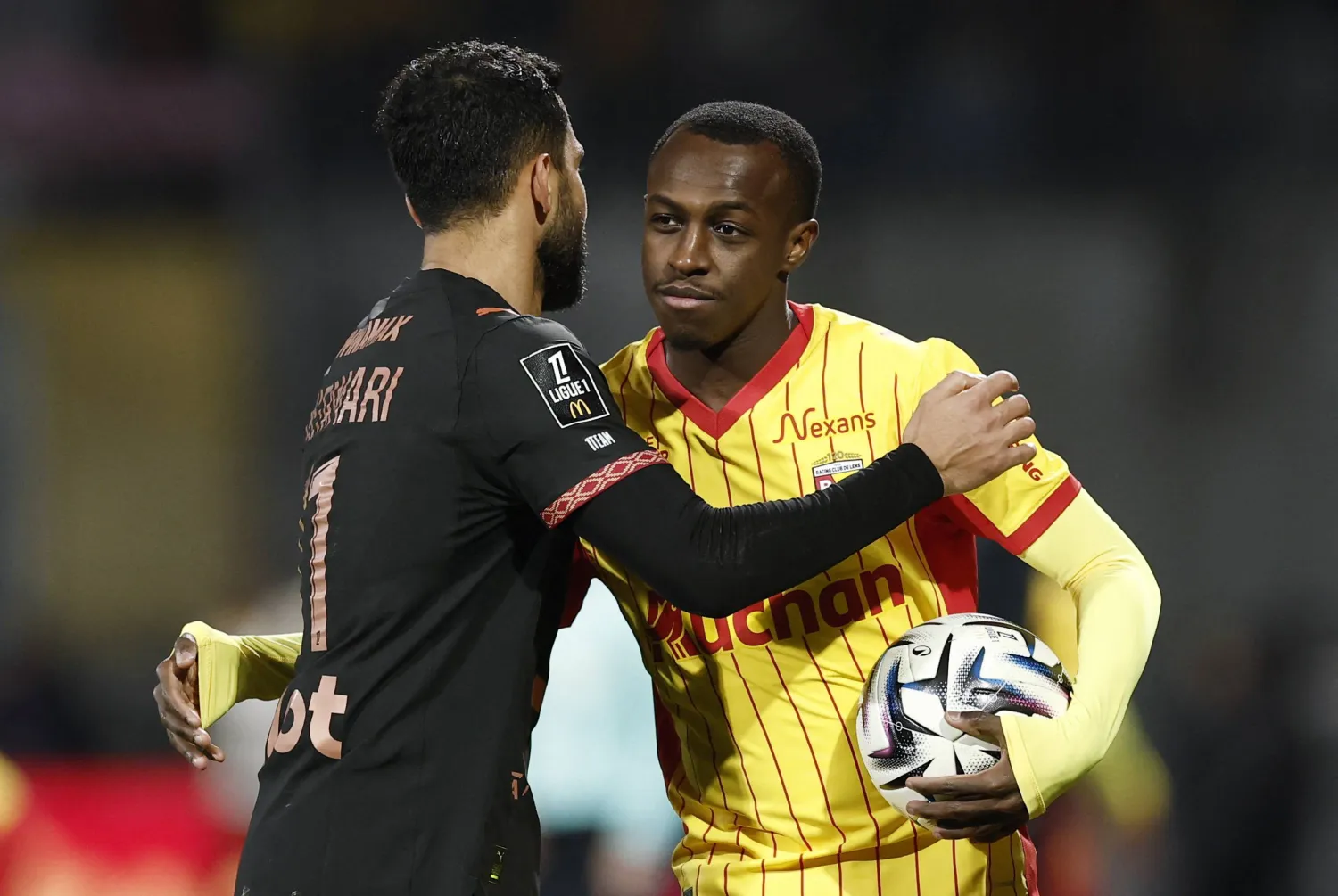 سعود عبد الحميد «يمين» يصافح موسى التعمري بعد نهاية مباراة لانس ورين (رويترز)