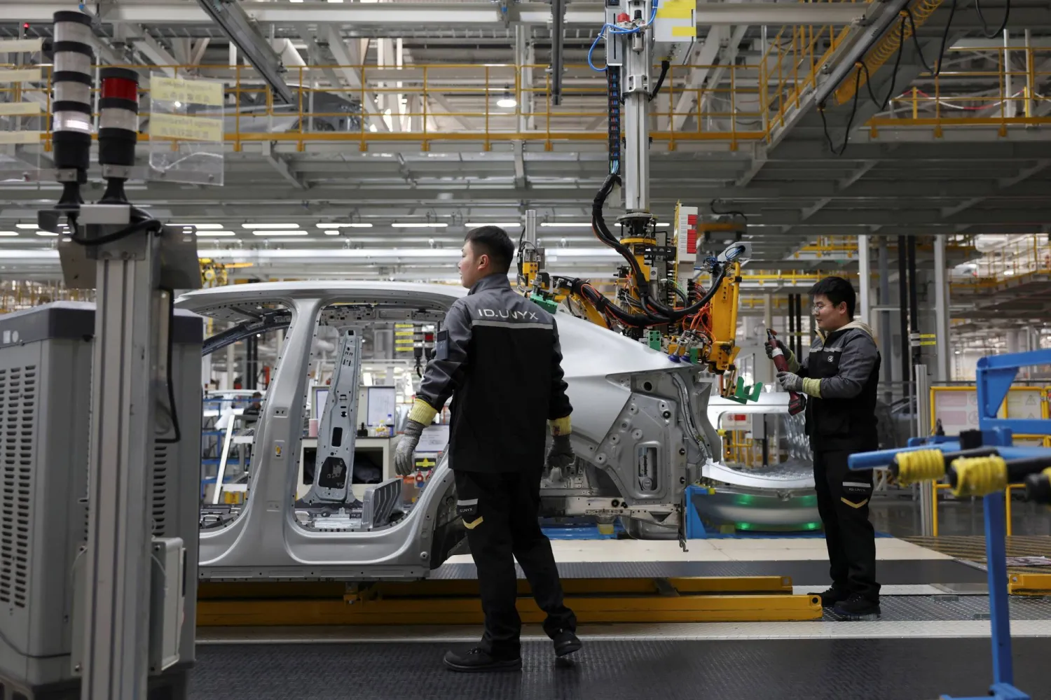 Employees work on an electric vehicle (EV) production line at the Volkswagen Anhui factory in Hefei, Anhui province, China, February 4, 2026. REUTERS/Florence Lo