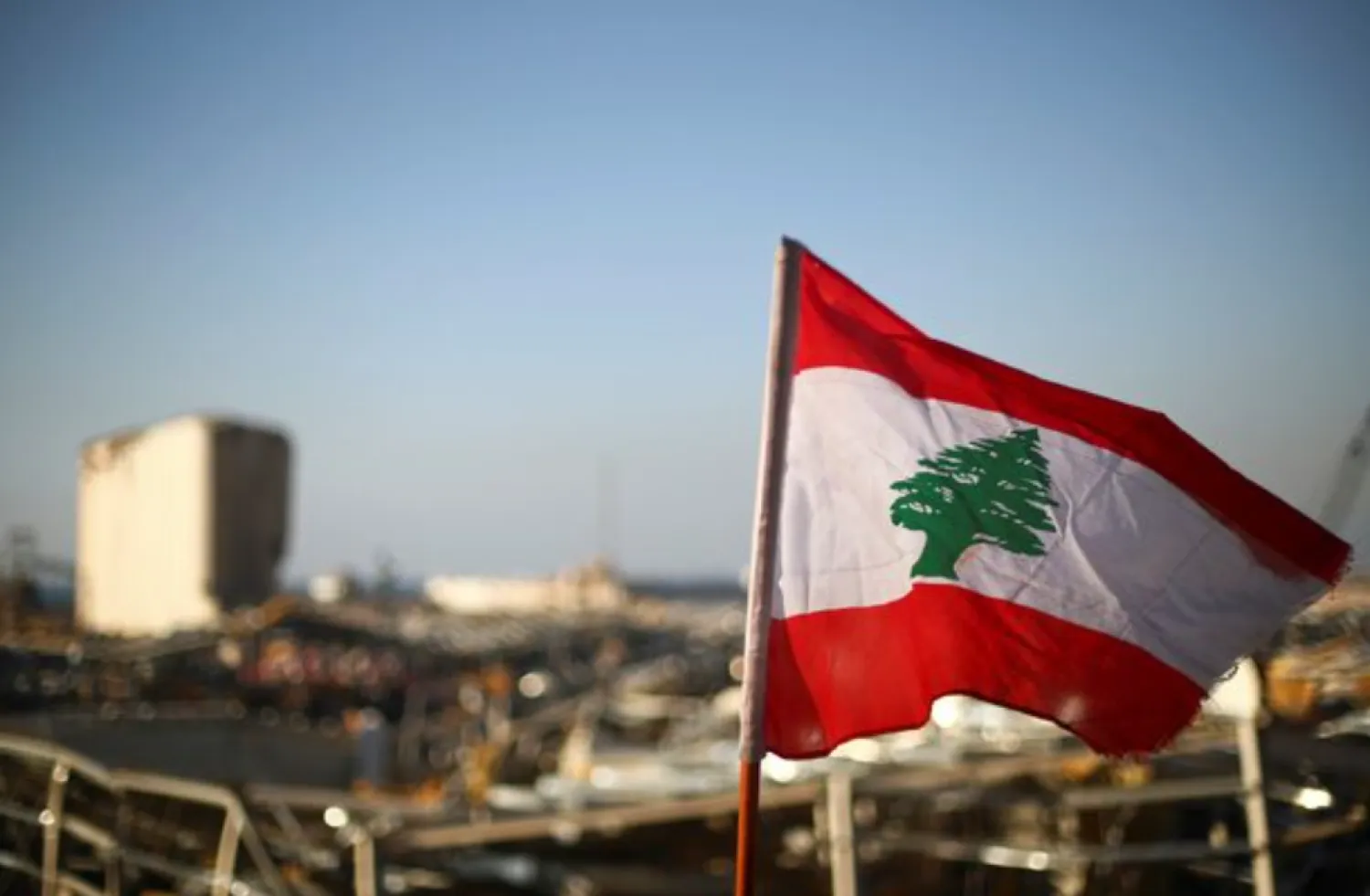 A Lebanese flag is pictured, in the aftermath of a massive explosion, in Beirut's damaged port area, Lebanon August 17, 2020. REUTERS/Hannah McKay 