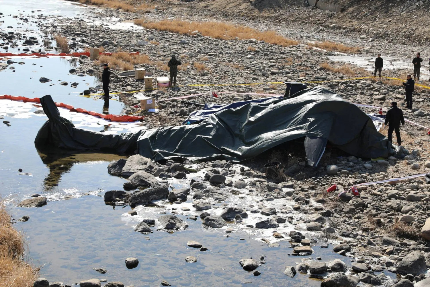 South Korean military officials secure the site where an AH-1S Cobra attack helicopter crashed in Gapyeong, South Korea, February 9, 2026. Yonhap via REUTERS   