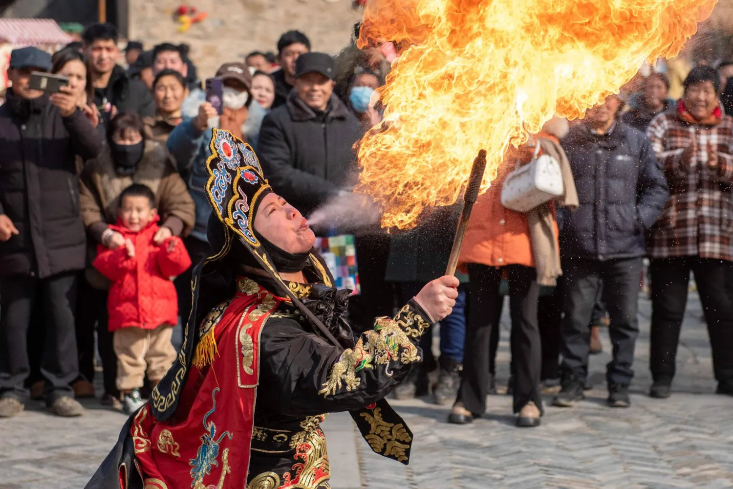 A folk performer breathes fire during a performance ahead of Lunar New Year celebrations in a village in Huai'an, in China's eastern Jiangsu Province on February 7, 2026. (AFP)