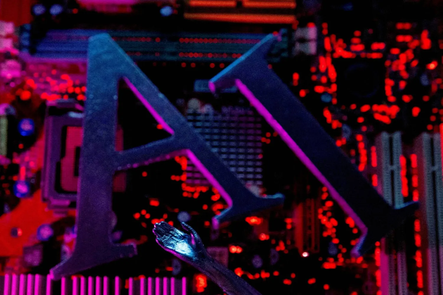 AI (Artificial Intelligence) letters and a robot hand are placed on a computer motherboard in this illustration created on June 23, 2023. (Reuters)
