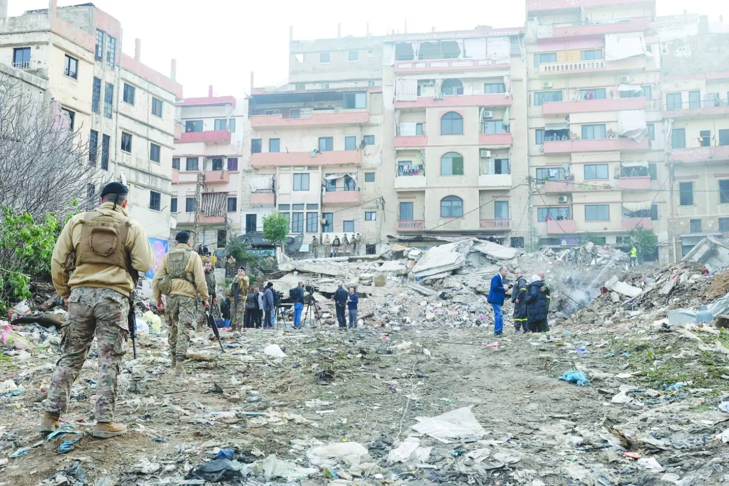 People stand at the site of the collapsed residential building in Tripoli, Lebanon, 09 February 2026. EPA/WAEL HAMZEH