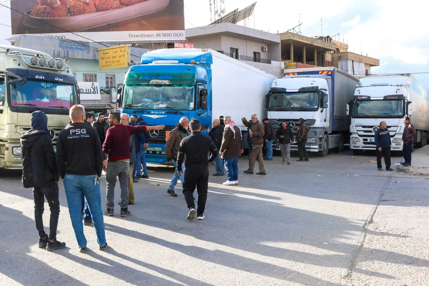 Lebanese truck drivers block the road on the Lebanese side of the Masnaa border crossing in protest against Syria's decision to ban non-Syrian trucks from entering its territory, on February 10, 2025. (AFP) 