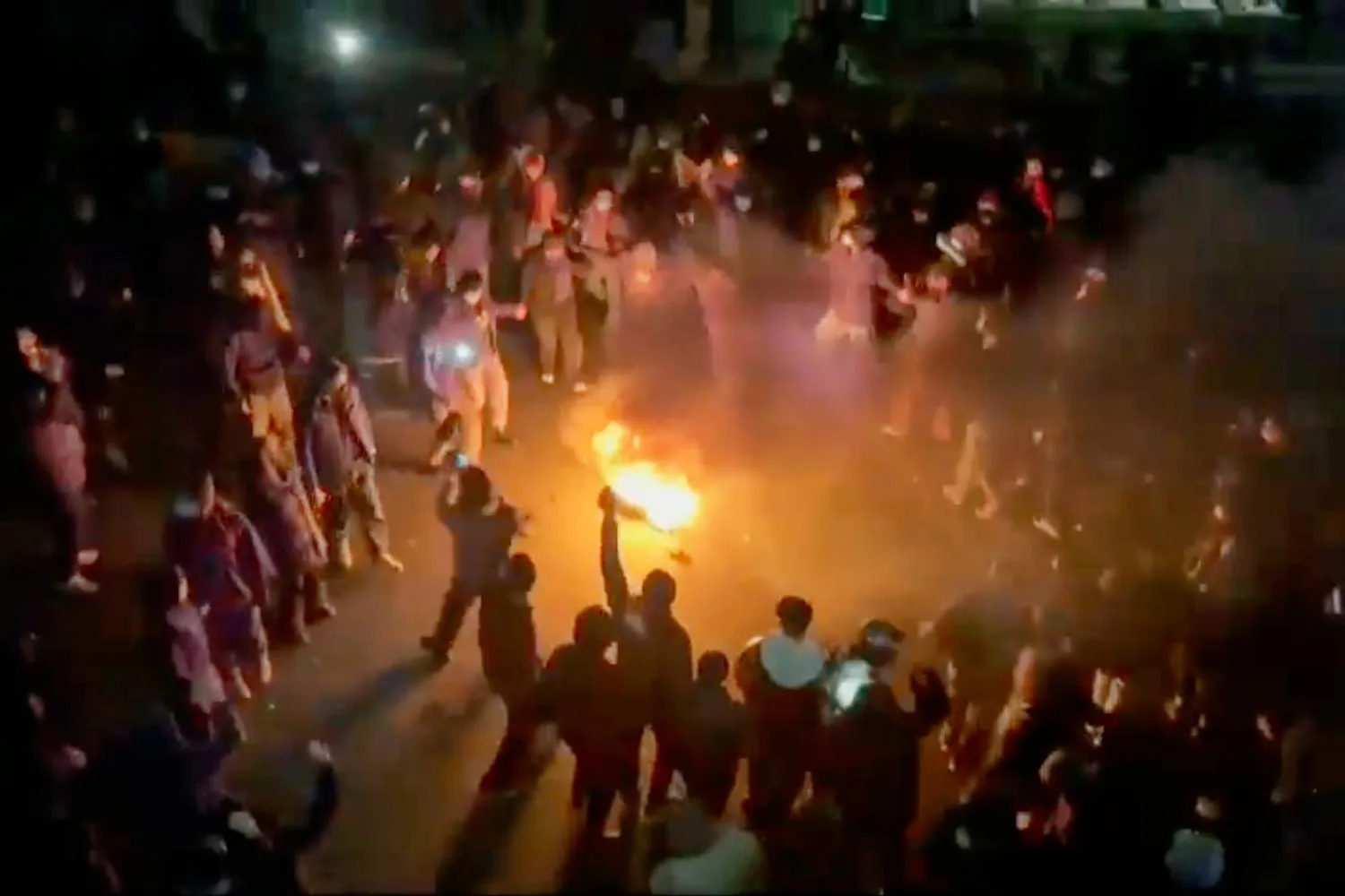 FILE - This frame grab from footage circulating on social media shows protesters dancing and cheering around a bonfire as they take to the streets, in Tehran, Iran, Jan. 9, 2026. (UGC via AP, File)