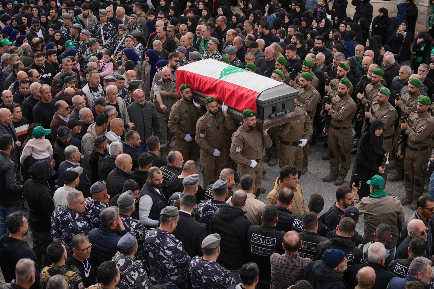 Lebanese special forces policemen carry the coffins of their comrade Hassan Jaber, who was killed on Monday with his son Ali, by an Israeli drone attack, during their funeral procession in Yanouh village, south Lebanon, Tuesday, Feb. 10, 2026. (AP)