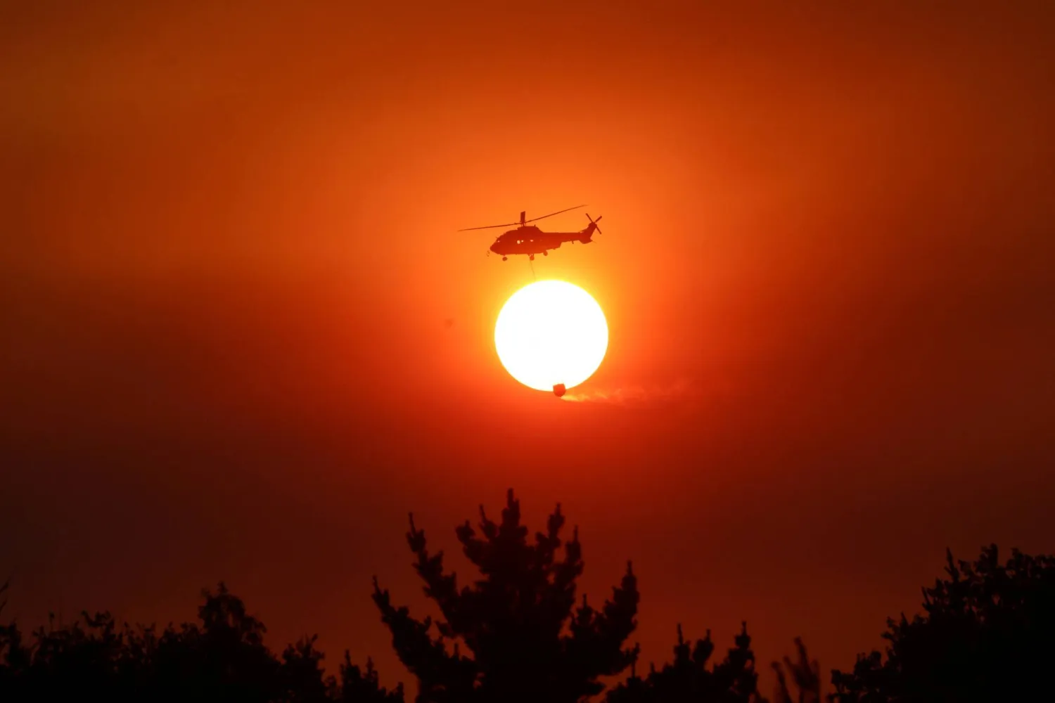 A helicopter battles a forest fire in the Biobio region, where multiple wildfires have prompted emergency evacuations, in Florida, Chile, January 21, 2026. (Reuters)