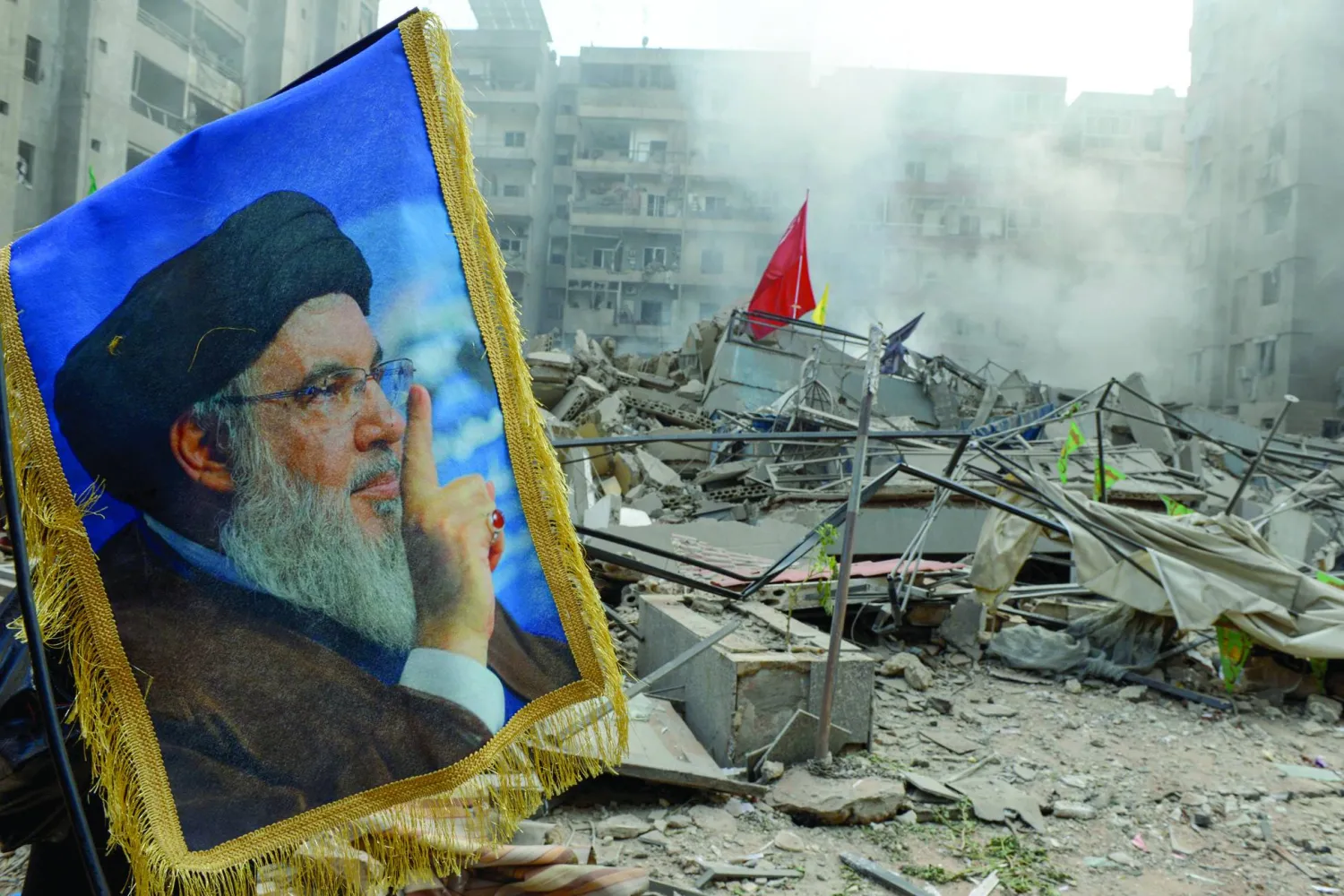 01 November 2024, Lebanon, Beirut: A picture of assassinated Hezbollah leader Hassan Nasrallah is displayed in front of rubble of flattened building caused by Israeli air raids on Beirut southern suburb. Photo: Marwan Naamani/ZUMA Press Wire/dpa