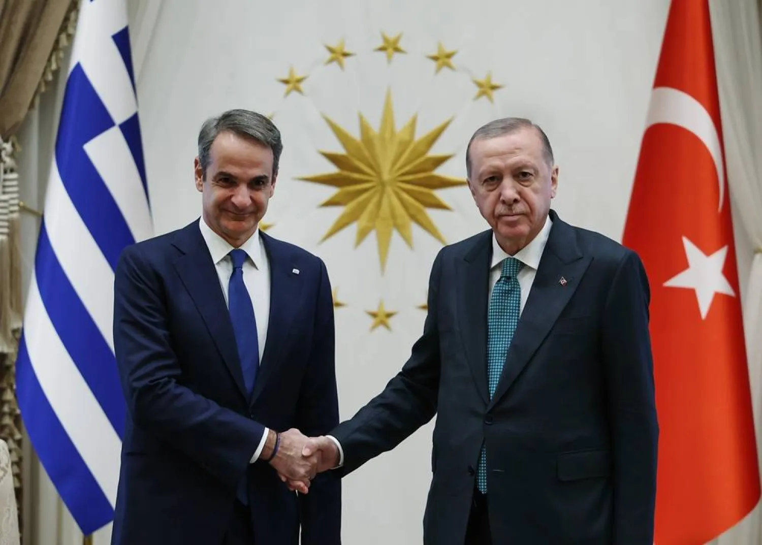 In this photo released by the Turkish Presidency, Türkiye’s President Recep Tayyip Erdogan, right, and Greece's Prime Minister Kyriakos Mitsotakis, shake hands during their meeting in Ankara, Türkiye, Wednesday, Feb. 11, 2026. (Turkish Presidency via AP) 