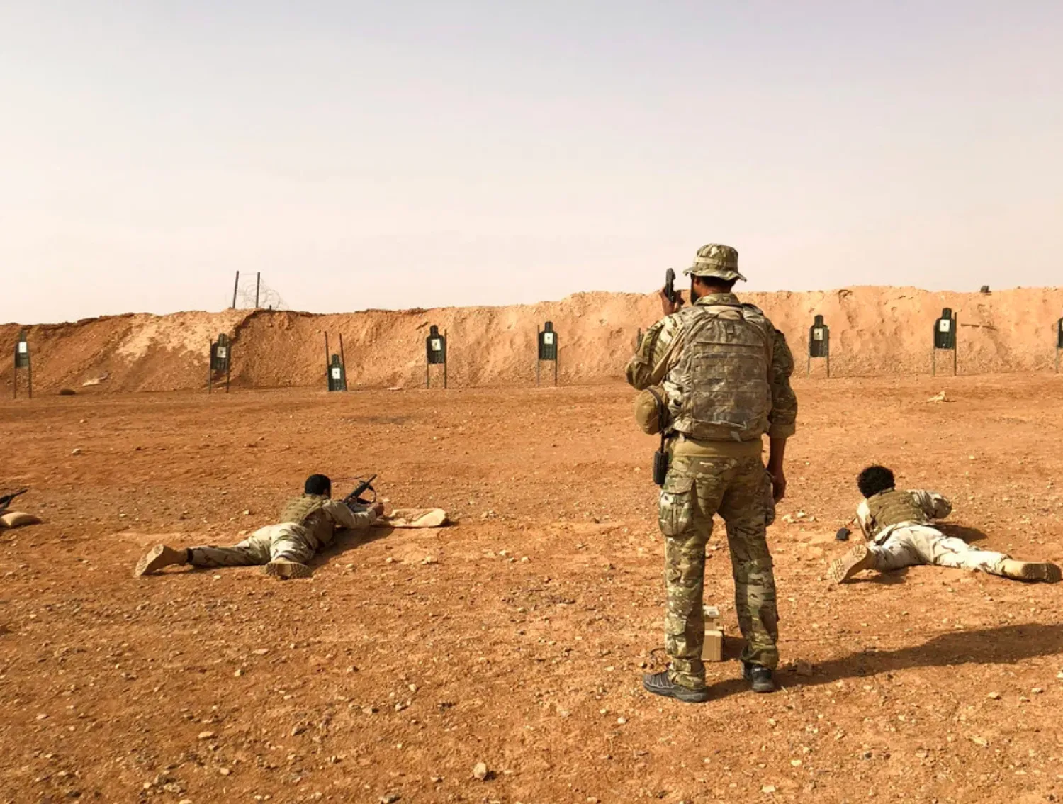 FILE: Members of the Maghawir al-Thawra Syrian opposition group receive firearms training from US Army Special Forces soldiers at the al-Tanf military outpost in southern Syria in 2018. (AP/Lolita Baldor)
