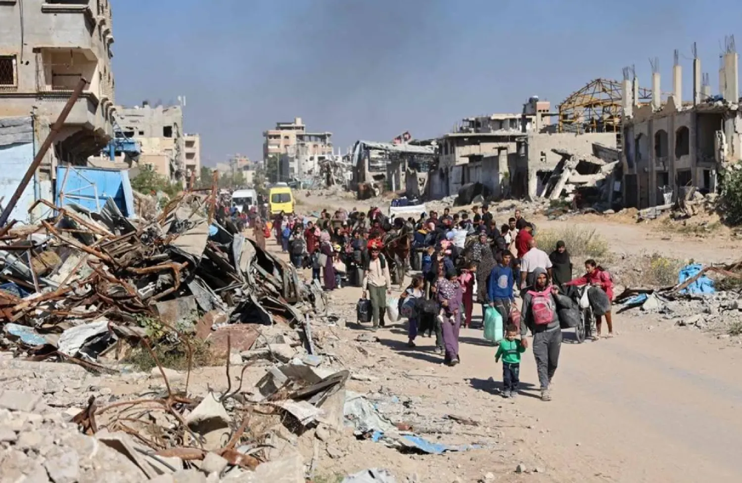 Displaced Palestinians fleeing Israeli military operations in Beit Lahia in the northern Gaza strip walk along the Salah al-Din main road in eastern Gaza City making their way to the city center, on October 22, 2024, amid the ongoing war in the Palestinian territory between Israel and Hamas. (AFP)
