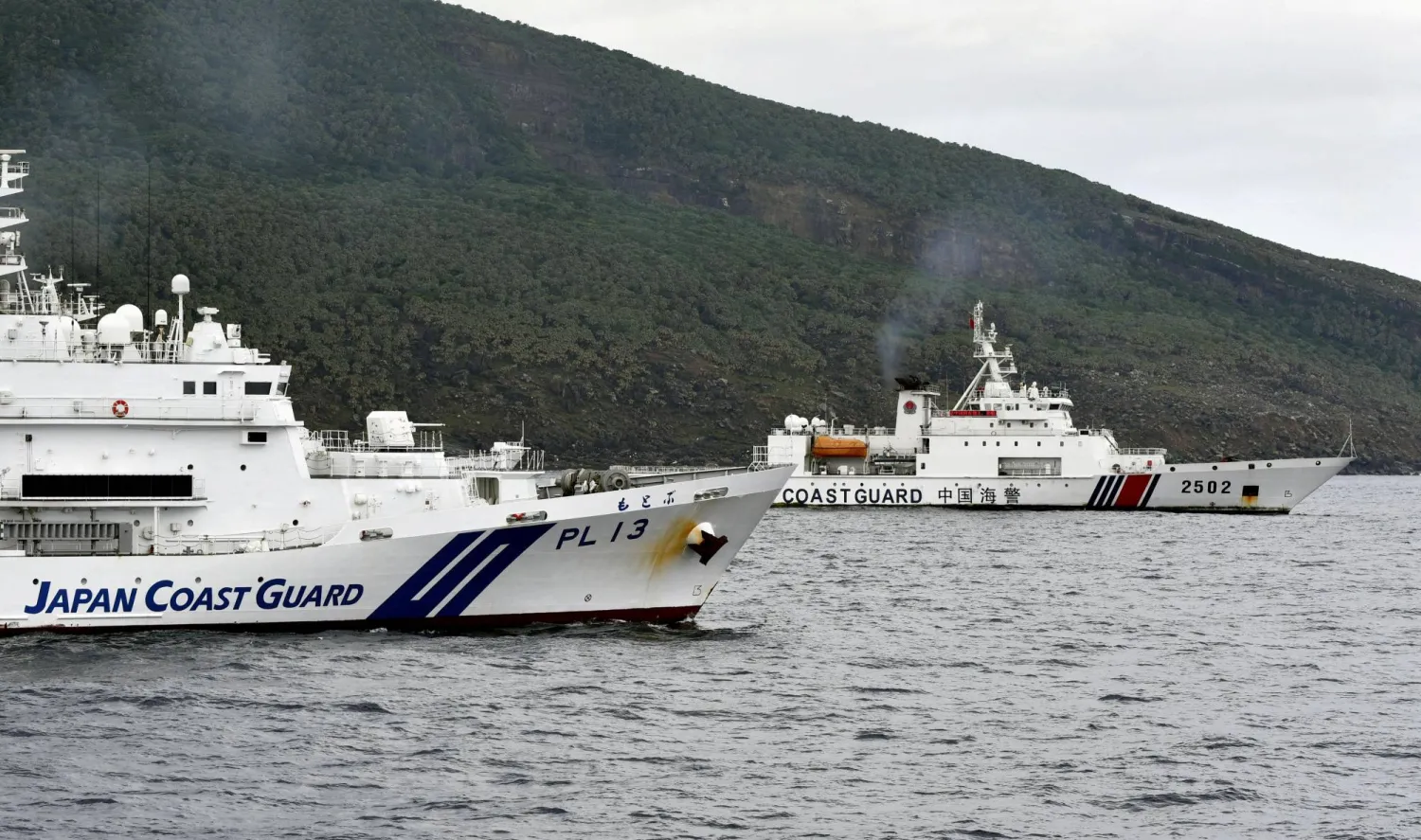 A China Coast Guard vessel No.2502 sails near a Japan Coast Guard vessel Motobu off Uotsuri Island, one of a group of disputed islands called Senkaku Islands in Japan, also known in China as Diaoyu Islands, in the East China Sea April 27, 2024, in this photo released by Kyodo. Mandatory credit Kyodo/via REUTERS   
