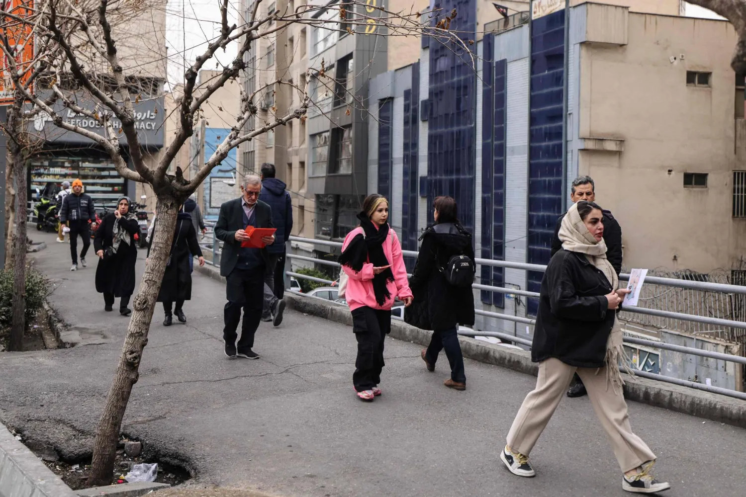Iranians walk on a street in Tehran on February 7, 2026. (AFP)