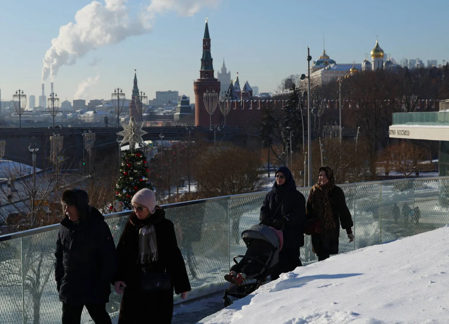 People walk along the Zaryadye Floating Bridge on a cold winter day, with the Kremlin in the background, in Moscow, Russia February 5, 2026. REUTERS/Anastasia Barashkova