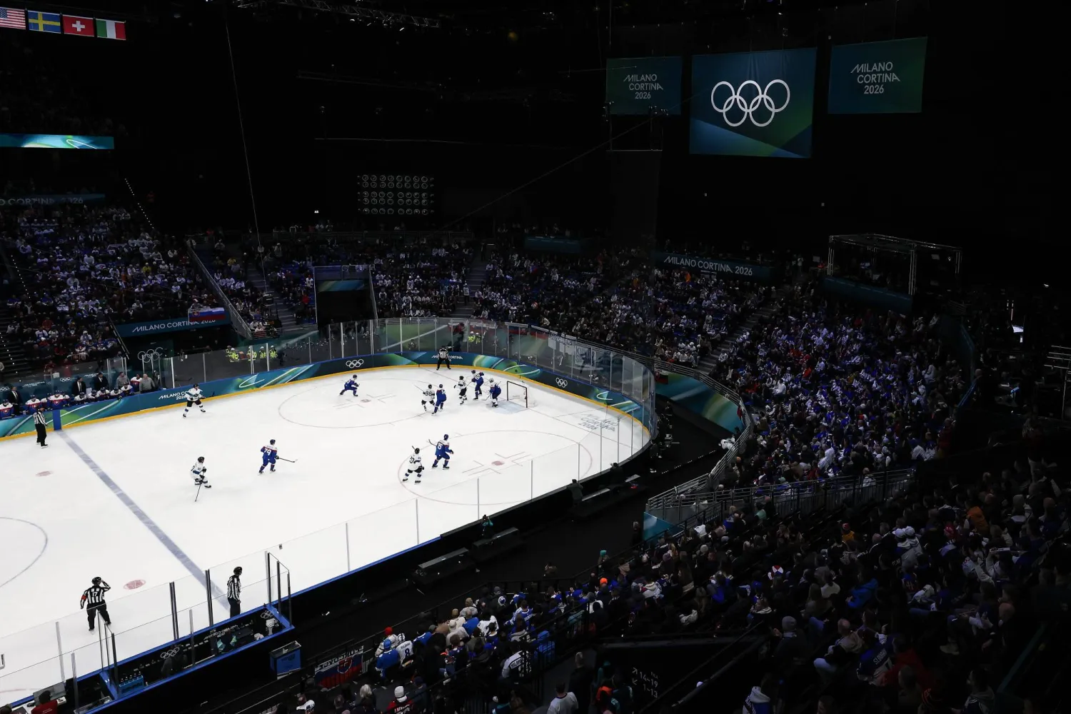 Finland players vie for the puck against Slovakia players during the Men's Preliminary Round match Slovakia against Finland of the Ice Hockey competitions, at the Milano Cortina 2026 Winter Olympic Games in Milano, Italy, 11 February 2026. (EPA)