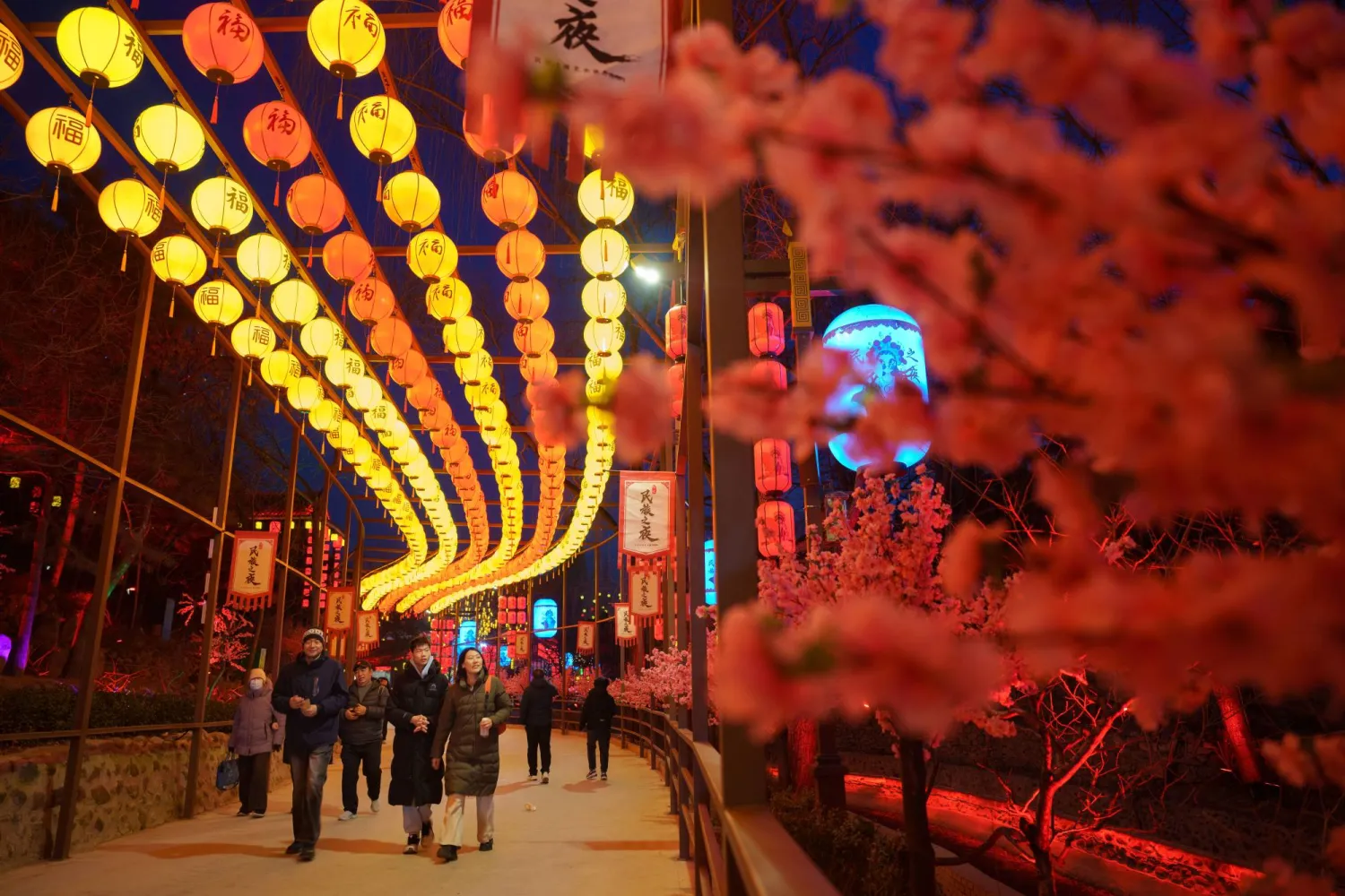 Visitors walk past illuminated lantern displays ahead of Lunar New Year in Beijing, China, Wednesday, Feb. 11, 2026. (AP Photo/Vincent Thian)