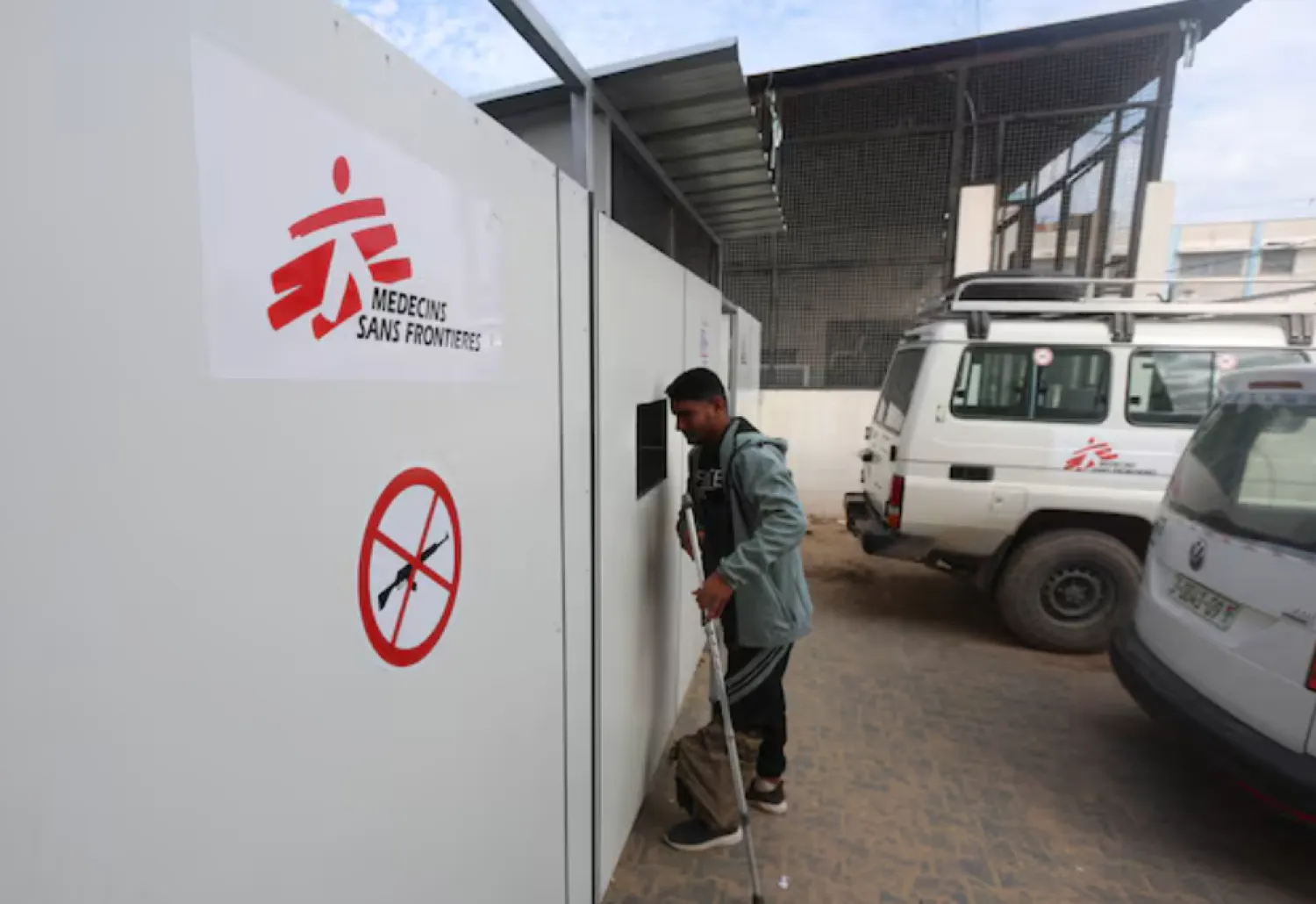 A Palestinian war-wounded man waits at the entrance, hoping to receive medical treatment, at a clinic run by medical charity Medecins Sans Frontieres (MSF), amid shortages of medical supplies, in Khan Younis, southern Gaza Strip, December 31, 2025. REUTERS/Ramadan Abed 