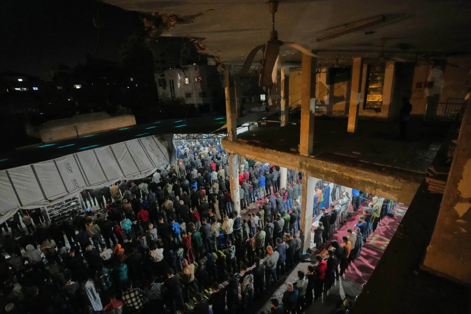 Worshippers perform evening Tarawih prayer on the first night of the holy fasting month of Ramadan at the Al-Kanz Mosque, which was damaged during the Israel-Hamas war, in Gaza City, Tuesday, Feb. 17, 2026. (AP) 