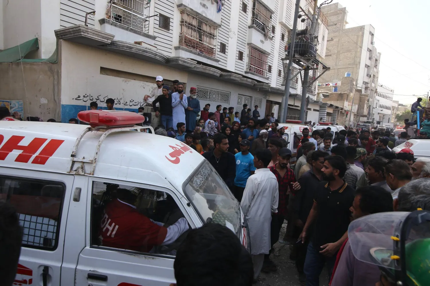 Rescue workers and people gather at the site of a residential compound following a suspected gas leakage blast in Karachi, Pakistan, 19 February 2026. EPA/REHAN KHAN
