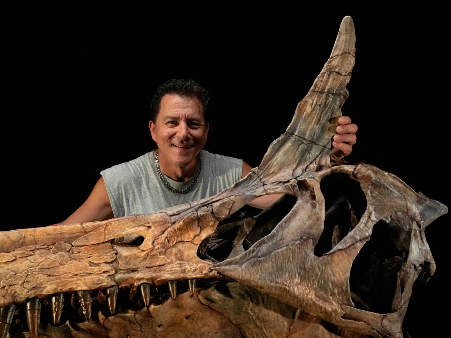 Paleontologist Paul Sereno poses in his Fossil Lab at the University of Chicago with a reconstructed skull of the dinosaur Spinosaurus mirabilis. The photograph was released by the University of Chicago on February 19, 2026. Keith Ladzinski/Handout via REUTERS