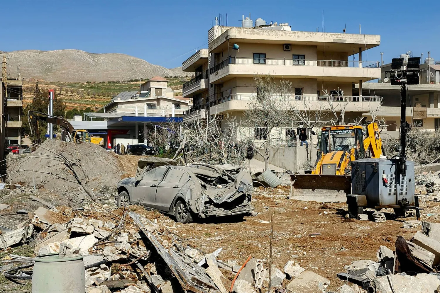 A bulldozer clears debris near heavily-damaged buildings in the village of Bednayel in Lebanon's eastern Bekaa Valley region on February 21, 2026, following Israeli strikes. (AFP)