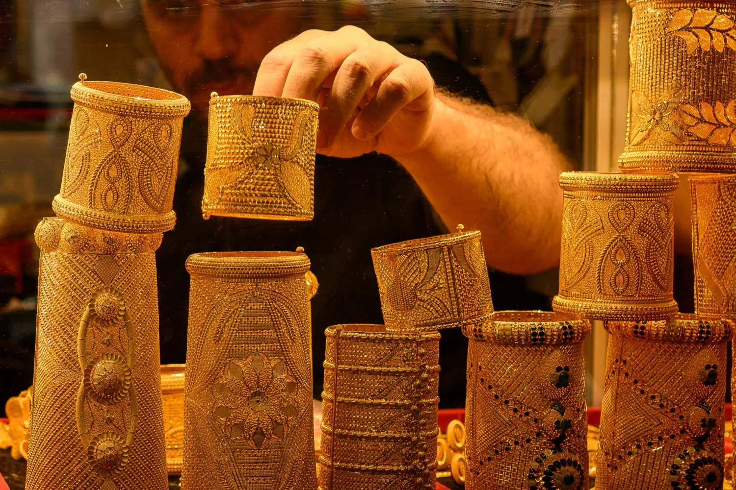A vendor displays gold bracelets for sale in a gold shop at the Grand Bazaar in Istanbul (AFP)