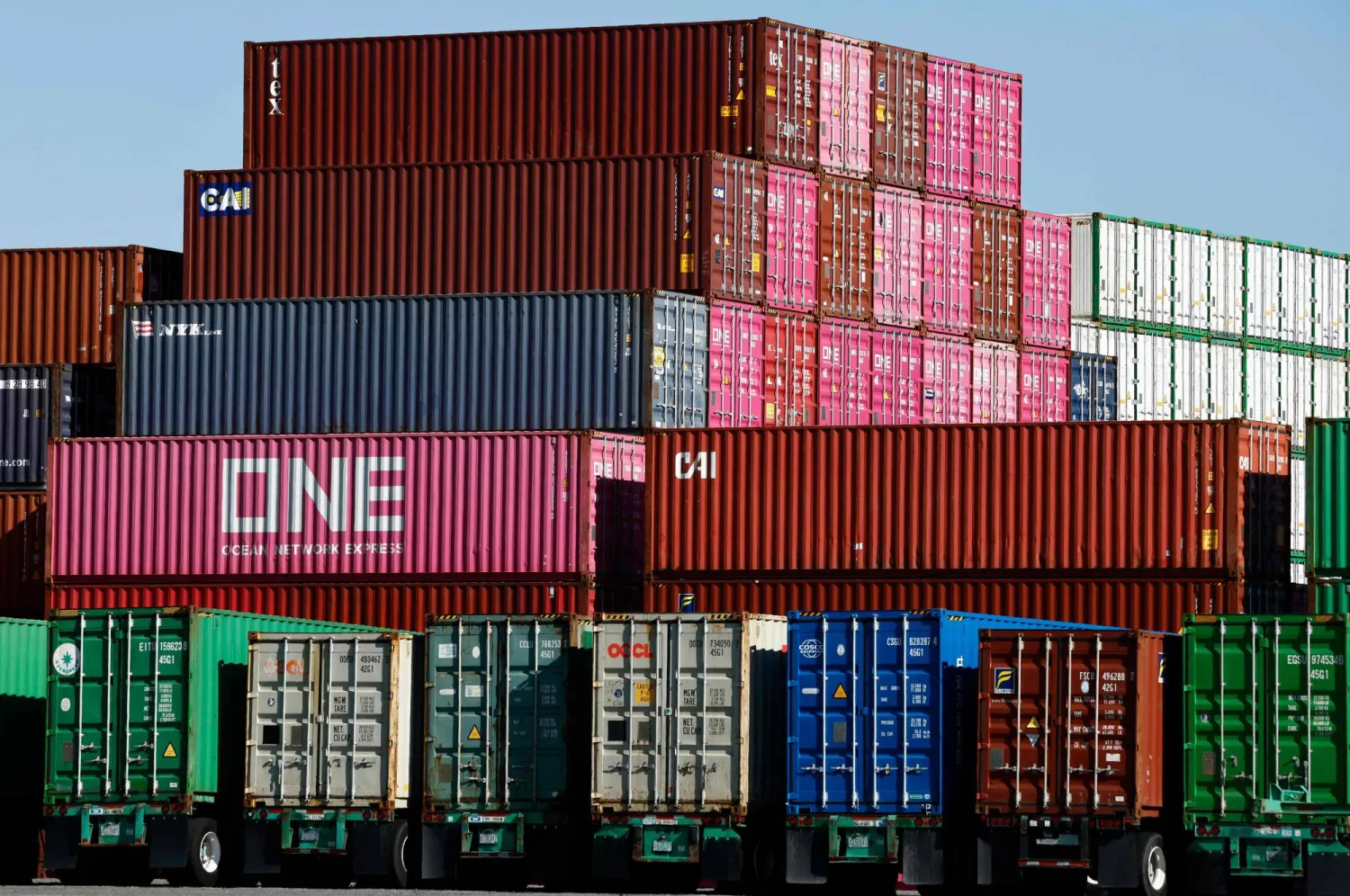 LOS ANGELES, CALIFORNIA - FEBRUARY 20: Shipping containers stand stacked while others rest on truck transport chassis at the Port of Los Angeles on February 20, 2026 in Los Angeles, California. Mario Tama/Getty Images/AFP