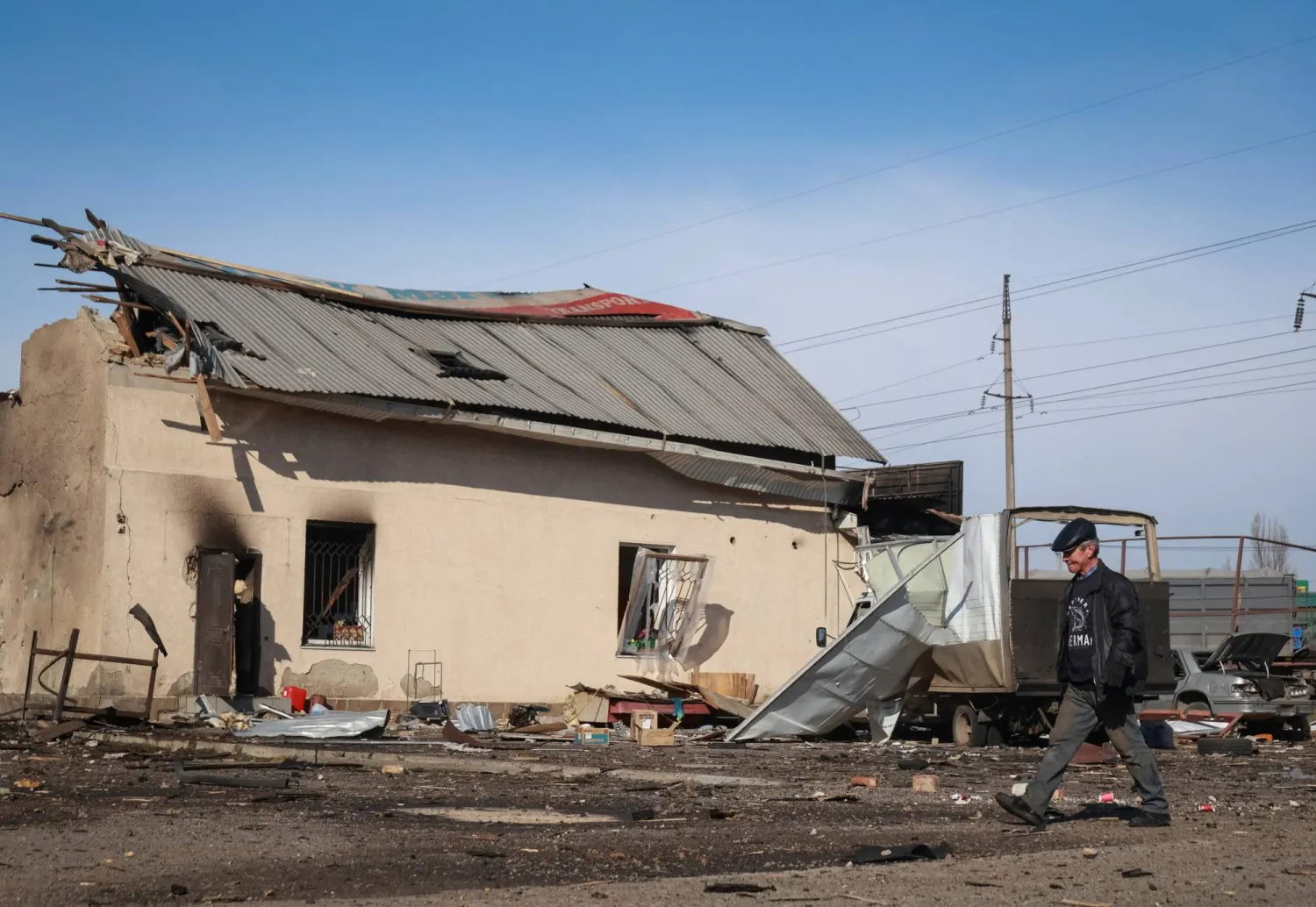 A resident walks at the site of the Russian drone strike, amid Russia's attack on Ukraine, near the city of Chornomorsk, Odesa region, Ukraine February 23, 2026. (Reuters)