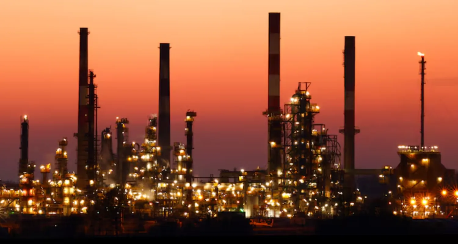 The chimneys of the Total Grandpuits oil refinery are seen just after sunset, southeast of Paris, France, March 1, 2021. REUTERS/Christian Hartmann 