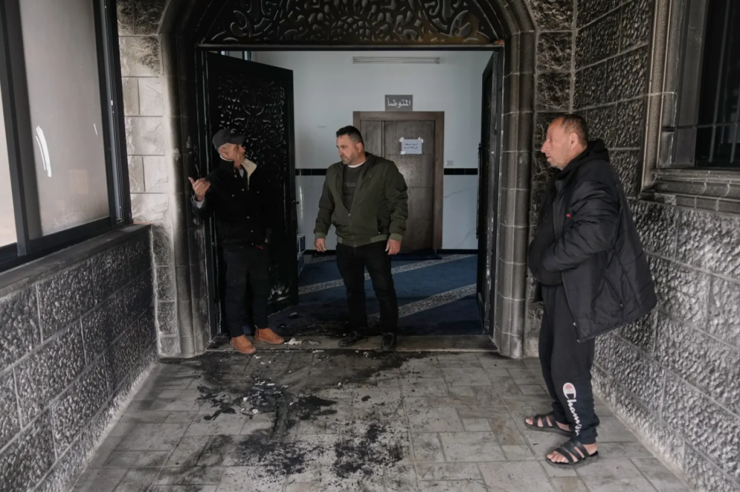 People check a fire-damaged area in the Abu Bakr al-Siddiq Mosque following, according to Palestinian authorities, an attack by Israeli settlers on the West Bank village of Tell, near Nablus, Monday, February 23, 2026. (AP Photo/Majdi Mohammed)