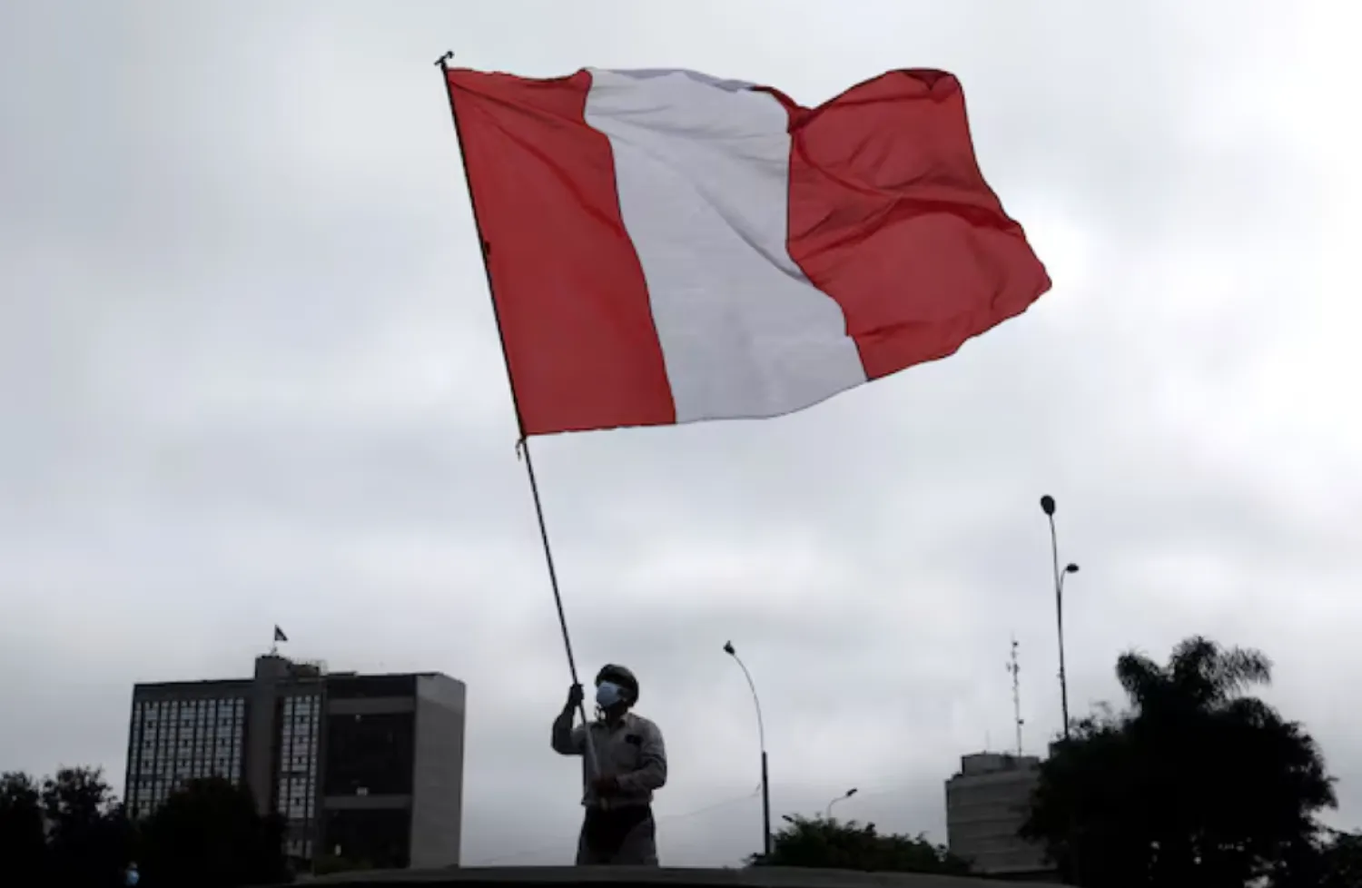A demonstrator waves a Peruvian flag during a protest against the government of President Pedro Castillo, in Lima, Peru October 8, 2021. REUTERS/Angela Ponce 