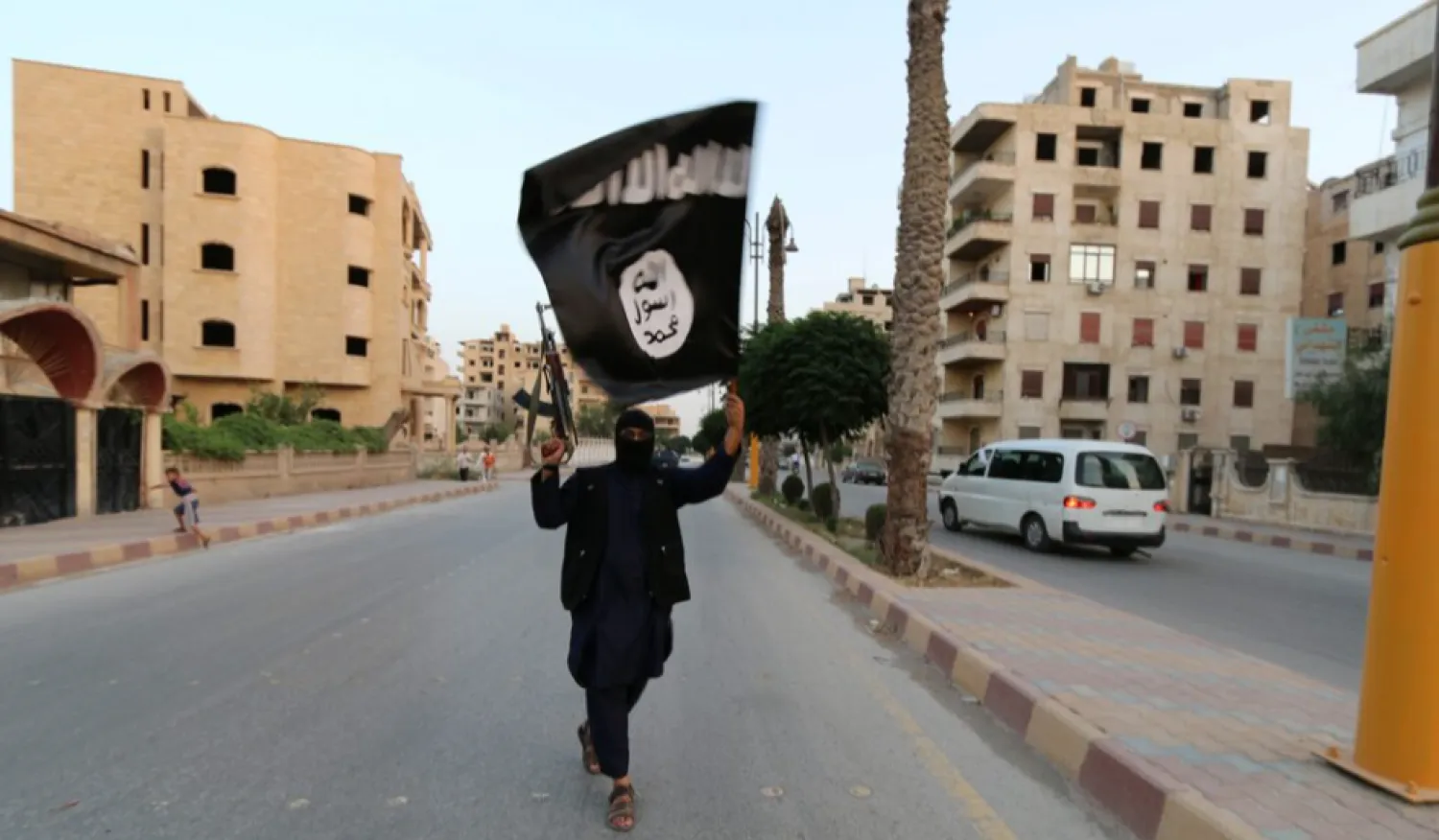 FILE PHOTO: A member loyal to the Islamic State waves an ISIS flag in Raqqa, Syria June 29, 2014. REUTERS/Stringer/Files