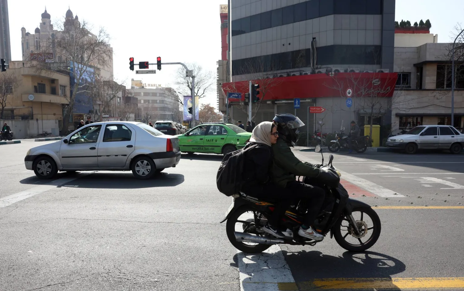 Iranians drive along a street in Tehran, Iran, 23 February 2026. (EPA)