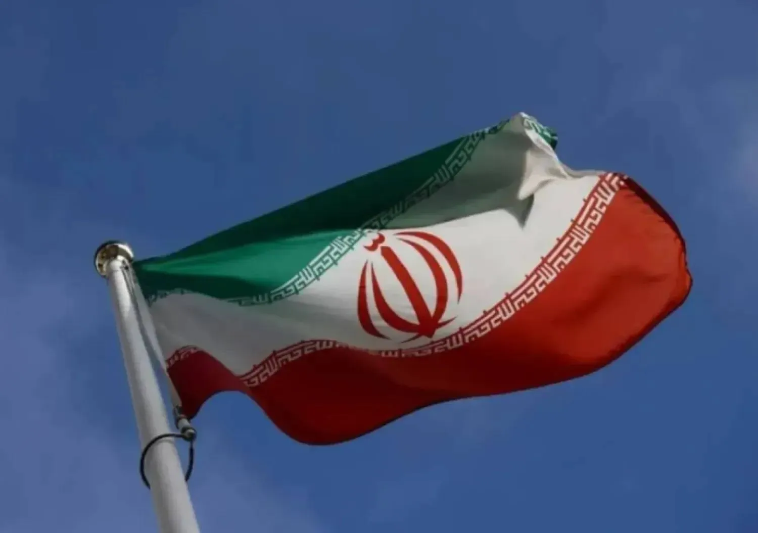 The Iranian flag waves in front of the International Atomic Energy Agency (IAEA) headquarters, before the beginning of a board of governors meeting, amid the coronavirus disease (COVID-19) outbreak in Vienna, Austria, March 1, 2021. (Reuters)

