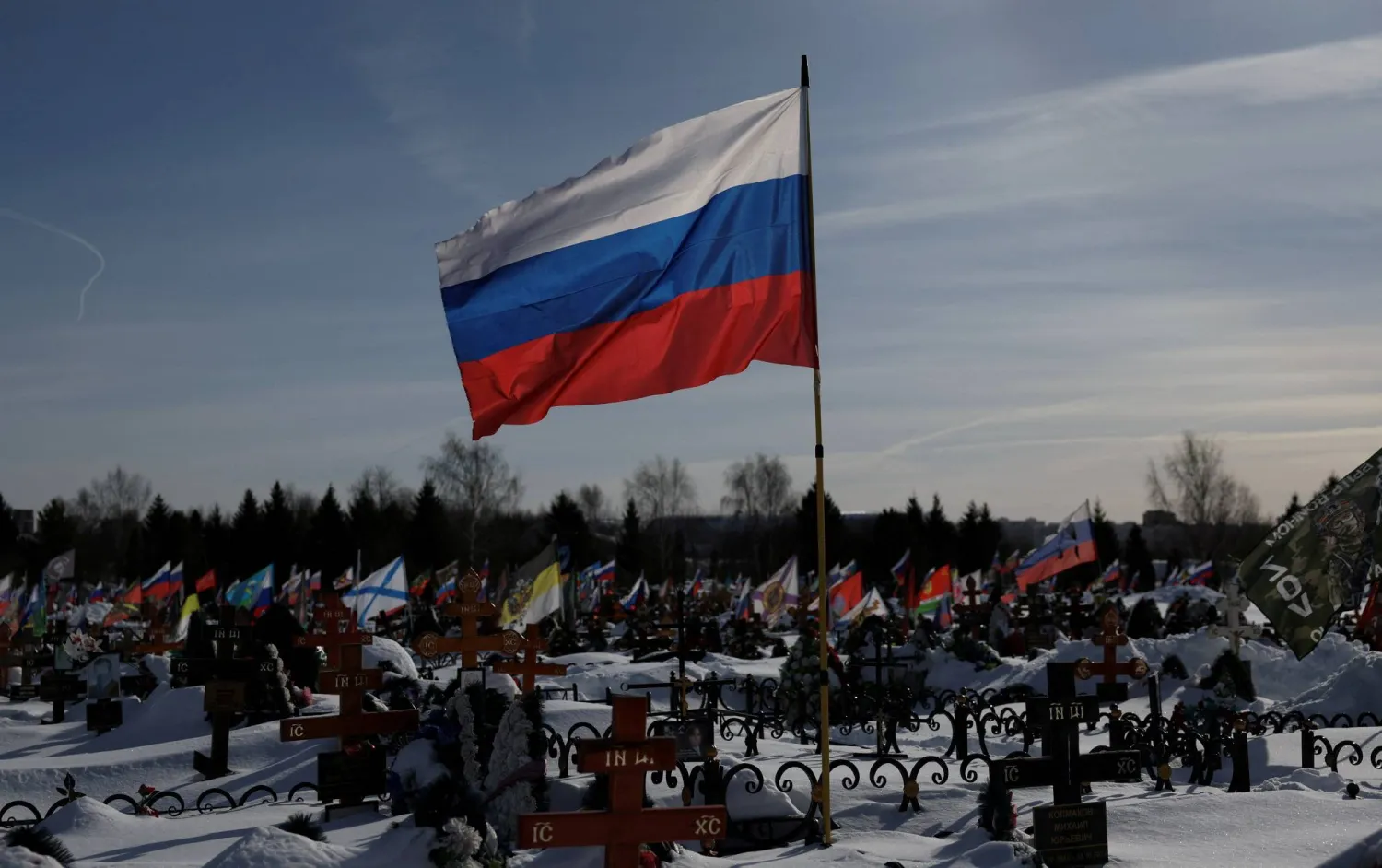 Flags fly over graves, including those of Russian soldiers killed during the conflict against Ukraine, on the eve of the fourth anniversary of the start of Russia’s military campaign, at Lemeshovo cemetery in the Moscow region, Russia, February 23, 2026. (Reuters)