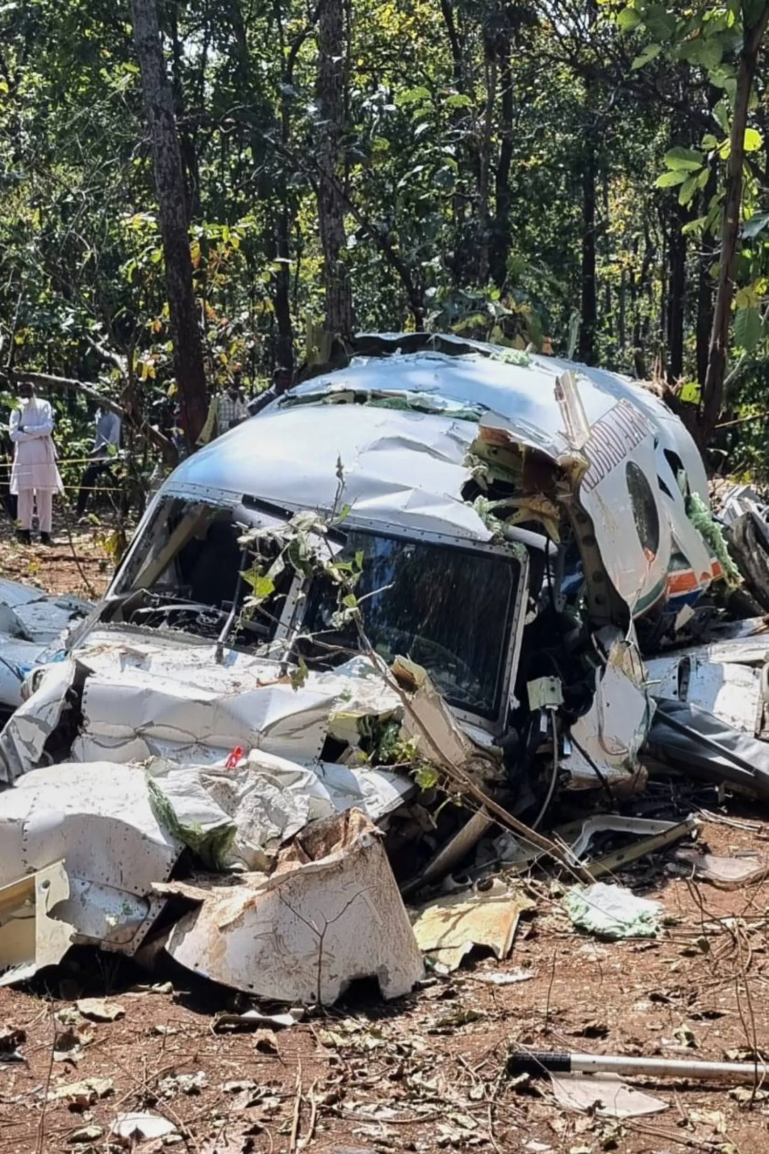 People watch wreckage of a Beechcraft C90 air ambulance aircraft after it crashed Monday into a forest near Ranchi, the capital of Indian state of Jharkhand, Tuesday, Feb.24, 2026. (AP Photo/Saikat Chatterjee)
