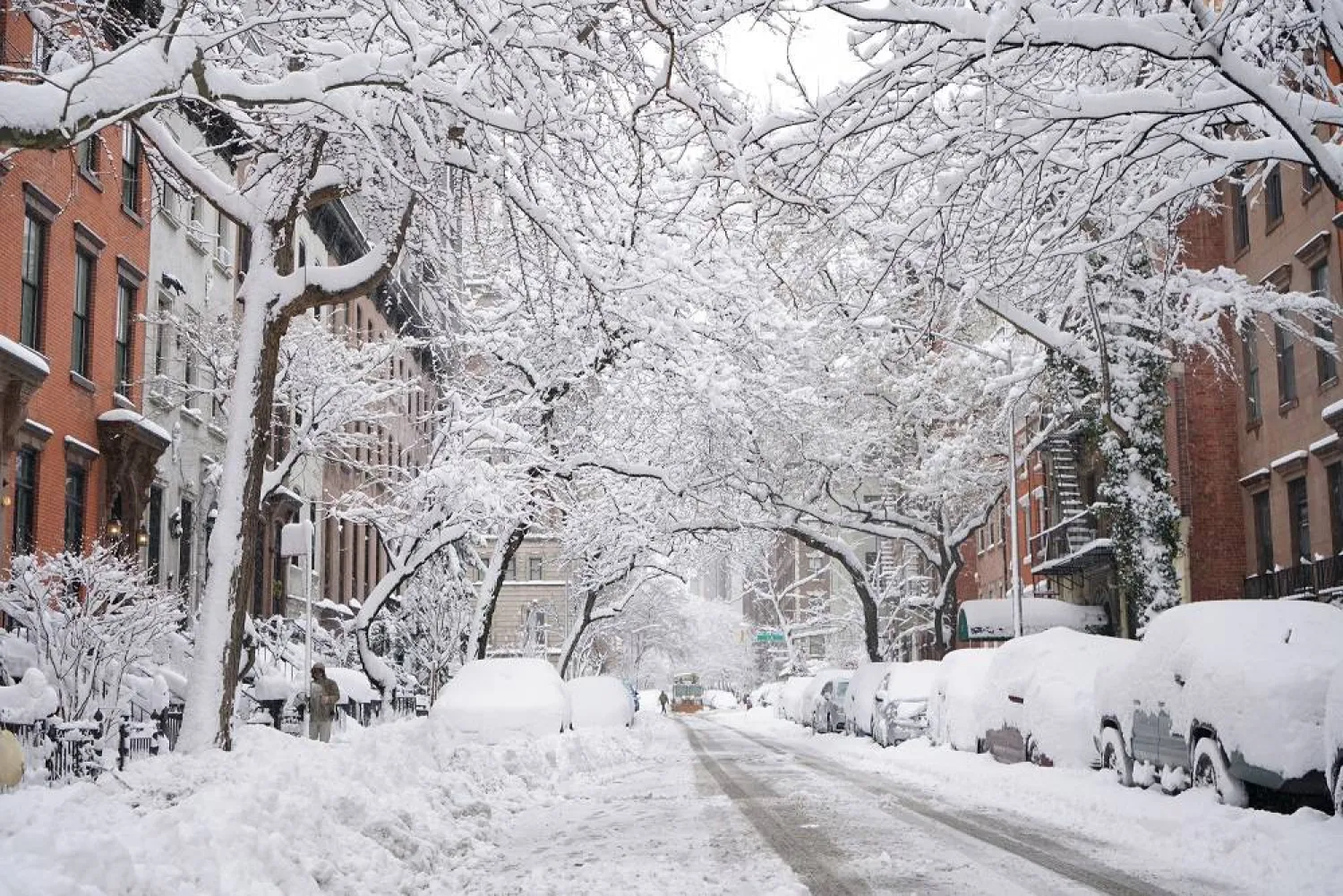 A snow plow crosses Second Avenue and heads down 19th Street to clear it after a snowstorm, Monday, Feb. 23, 2026, in New York. (AP)
