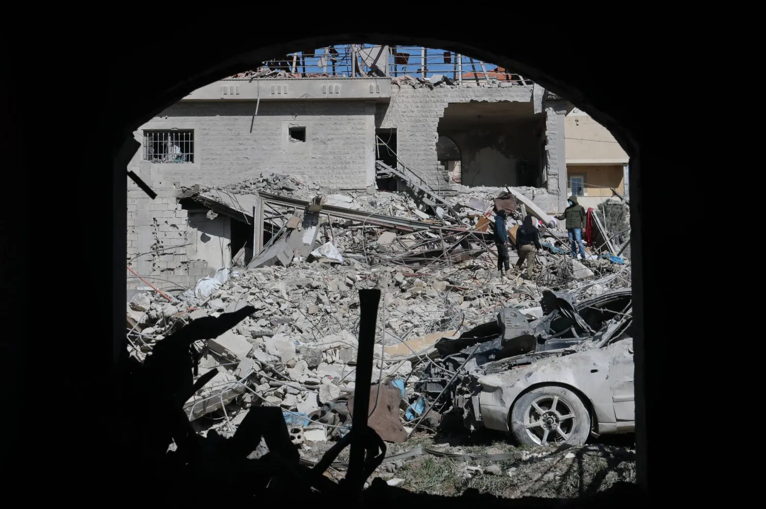 People gather near a building damaged in an Israeli strike in the village of Bednayel in eastern Lebanon, 21 February 2026. (EPA)