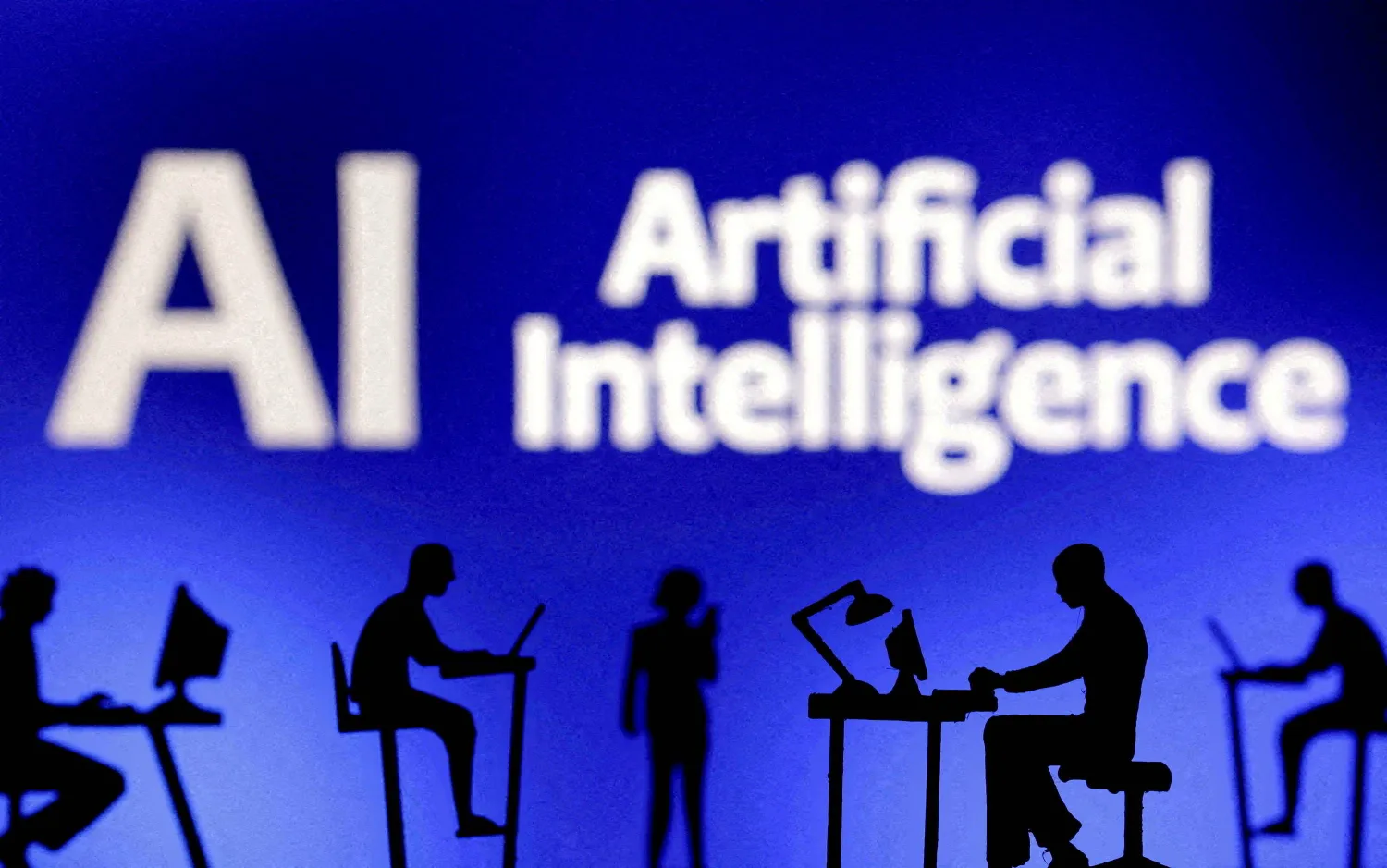 FILE PHOTO: Figurines with computers and smartphones are seen in front of the words "Artificial Intelligence AI" in this illustration taken, February 19, 2024. REUTERS/Dado Ruvic/Illustration/File Photo
