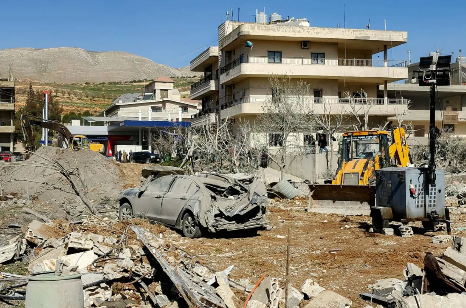 A bulldozer clears debris near heavily-damaged buildings in the village of Bednayel in Lebanon's eastern Bekaa Valley region on February 21, 2026, following Israeli strikes. (AFP)