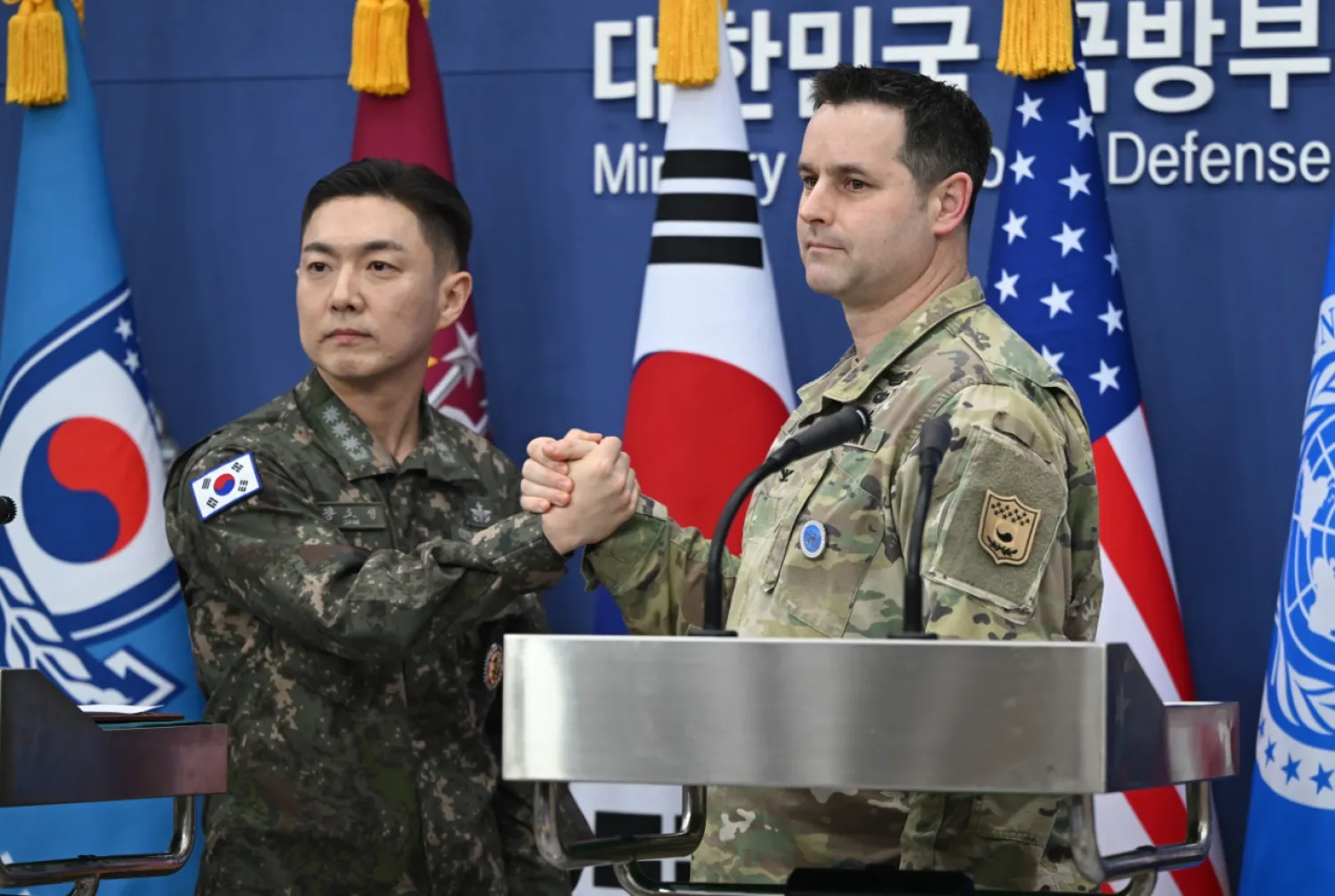 Col. Jang Do-young, left, public affairs director of South Korea's Joint Chiefs of Staff, and U.S. Army Col. Ryan Donald, public affairs director of the United Nations Command, Combined Forces Command, and United States Forces Korea, pose for a photo during a media briefing on the 2026 ROK-US Freedom Shield Military Exercise at the Defense Ministry in Seoul, South Korea, Wednesday, Feb. 25, 2026. (Jung Yeon-je/Pool Photo via AP)