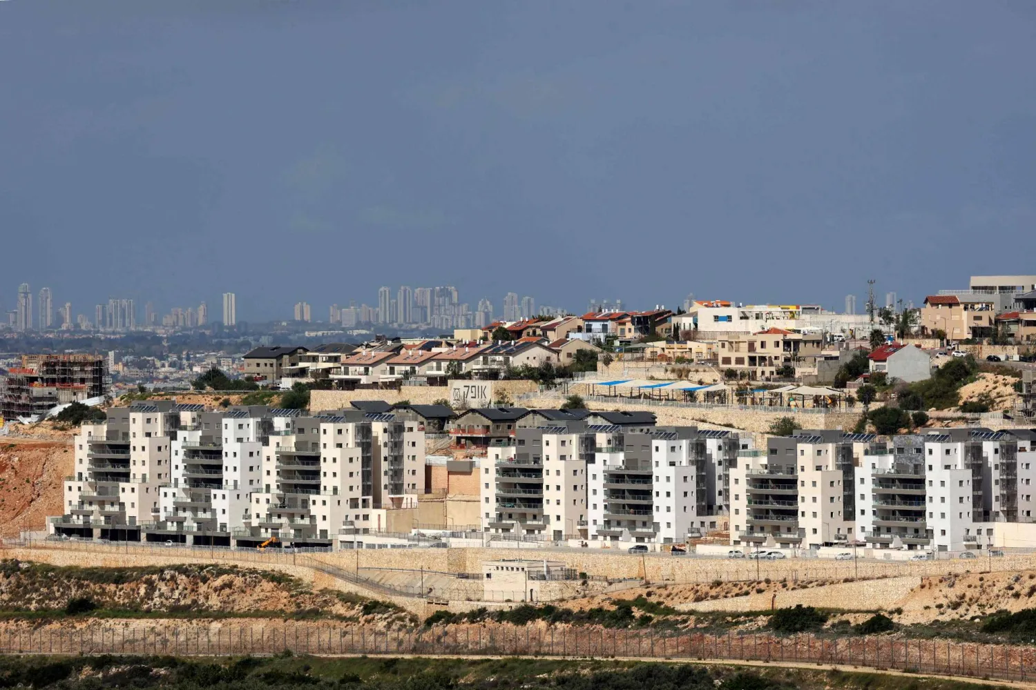  A view of the Israeli settlement of Tzufim in the north of Qalqilya city in occupied West Bank is pictured against the backdrop of Israeli city of Netanya on February 25, 2026. (AFP) 