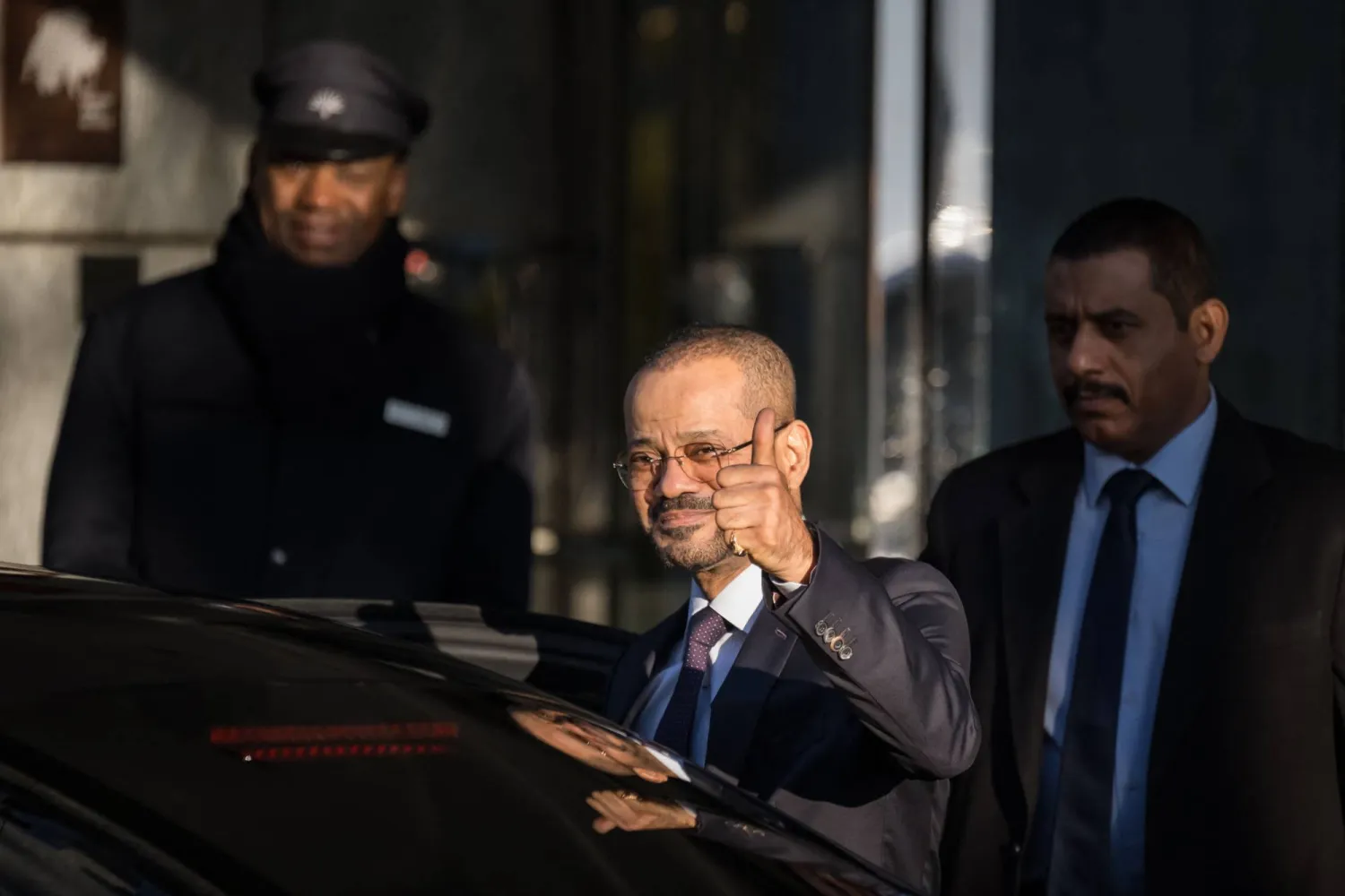Oman's Foreign Affairs Minister Badr bin Hamad al-Busaidi gives a thumbs up as he leaves his hotel to reach Oman's ambassador residency for new round of talks between the United States and Iran to address Iran's nuclear program, in Geneva on February 26, 2026. (Photo by Fabrice COFFRINI / AFP)