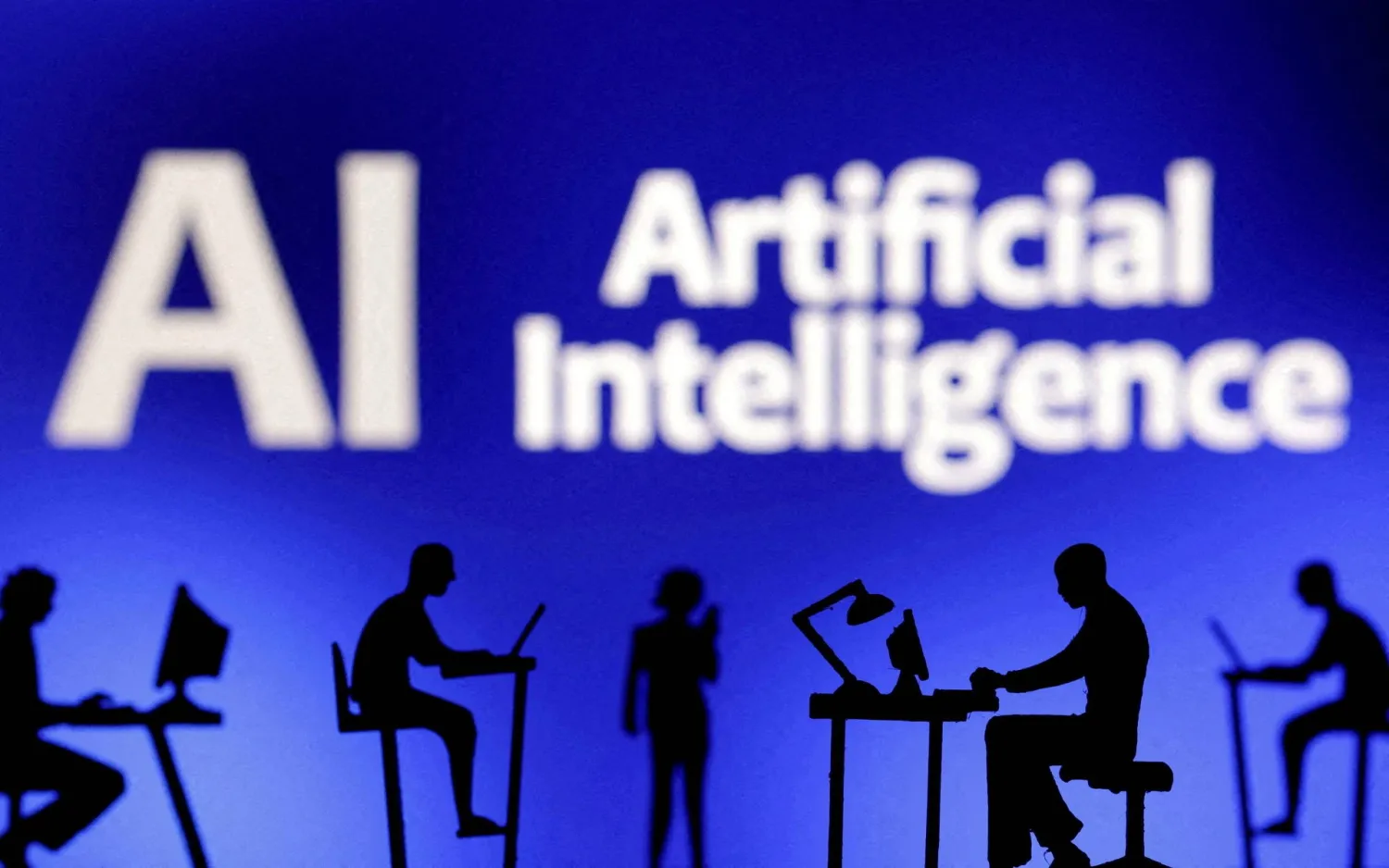 Figurines with computers and smartphones are seen in front of the words "Artificial Intelligence AI" in this illustration taken, February 19, 2024. REUTERS/Dado Ruvic/Illustration/File Photo 