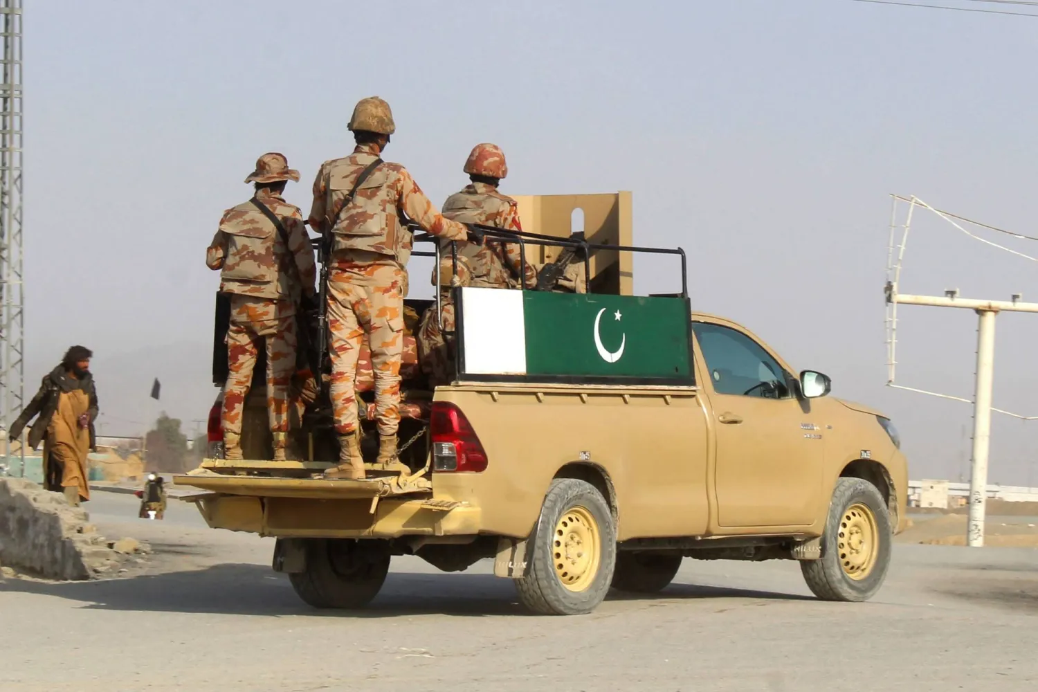 Pakistani soldiers patrol near the Pakistan-Afghanistan border crossing in Chaman on February 27, 2026. (Photo by Abdul BASIT / AFP)